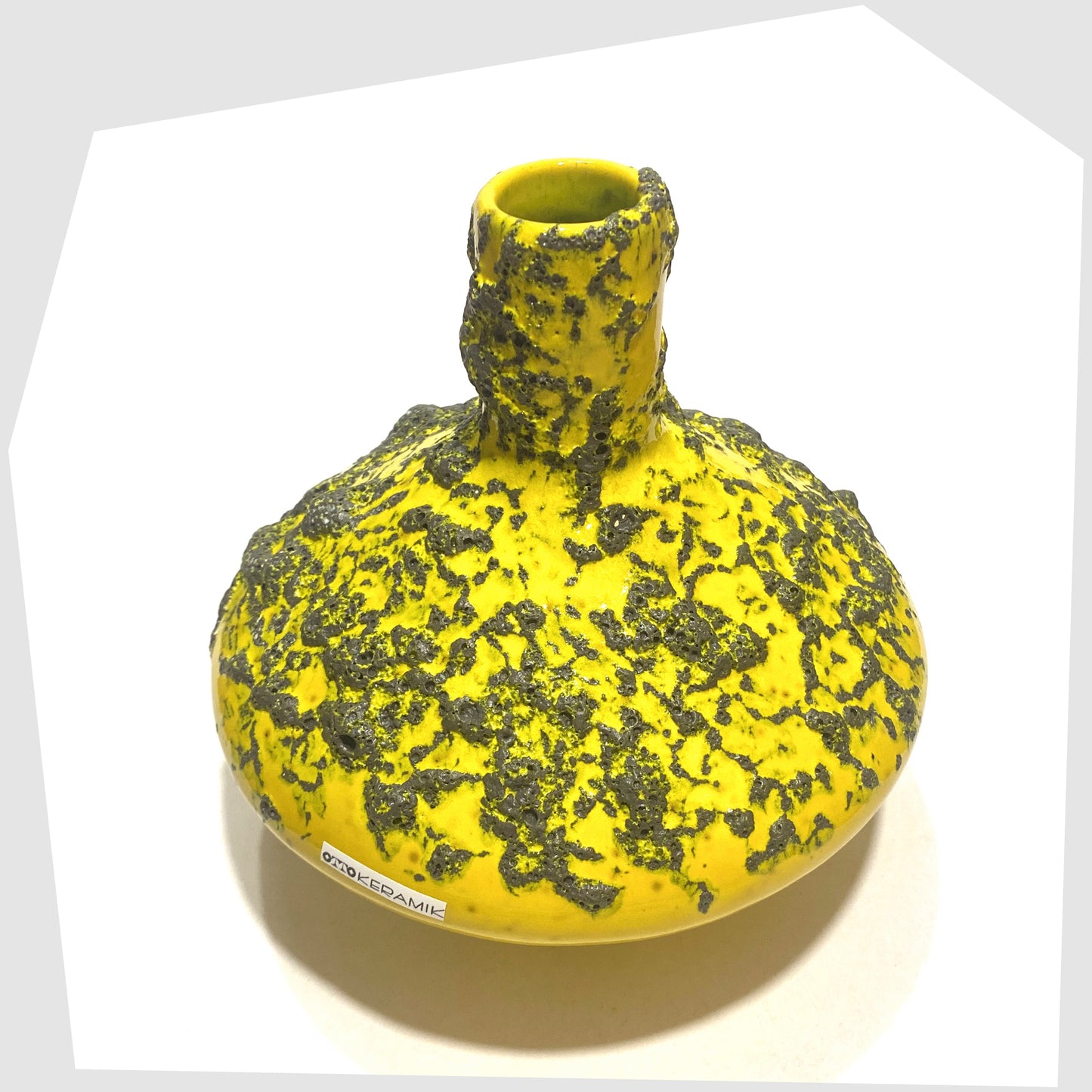 Overhead view of the Otto Keramik 206 Vase in vibrant yellow glaze with deep fat lava, shown on a white background