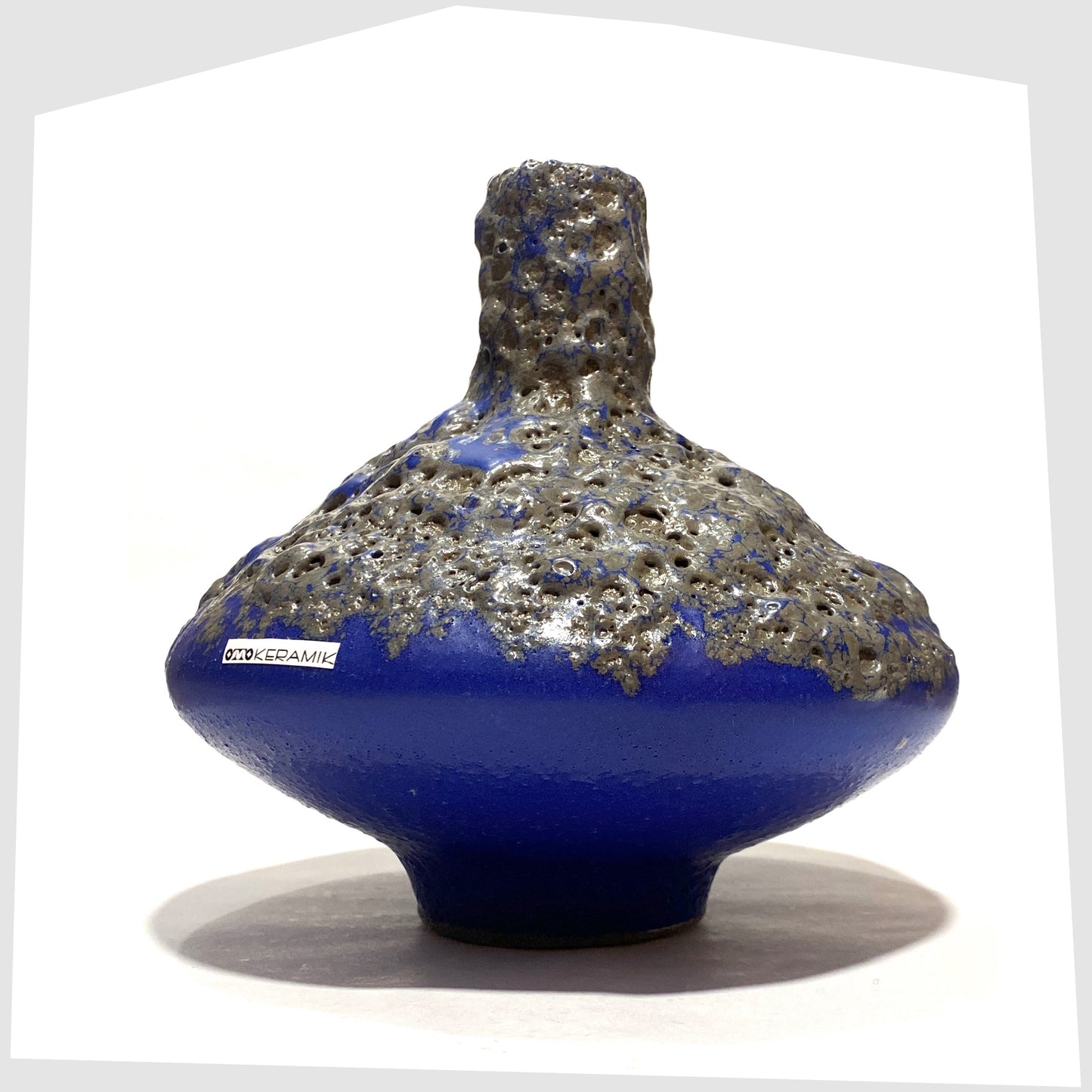 UFO shaped Otto Keramik 206 Vase in a vivid blue colour with grey fat lava glaze, shown on a white background