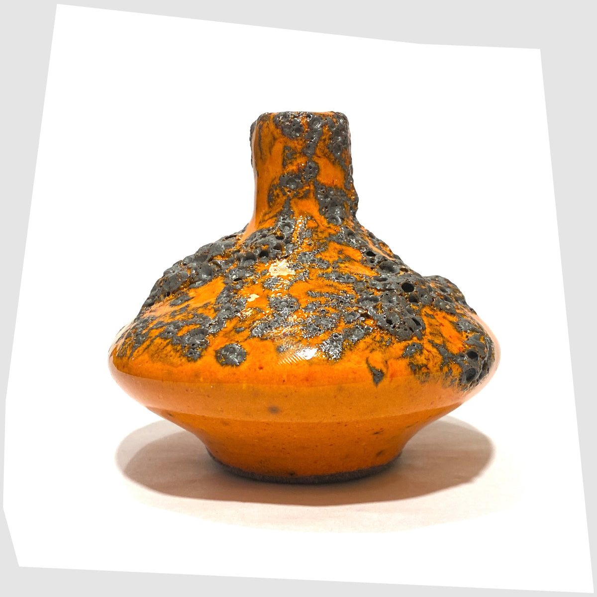 Rear of the Otto Keramik 206s Vase in a vibrant orange glaze with grey fat lava, shown on a white background