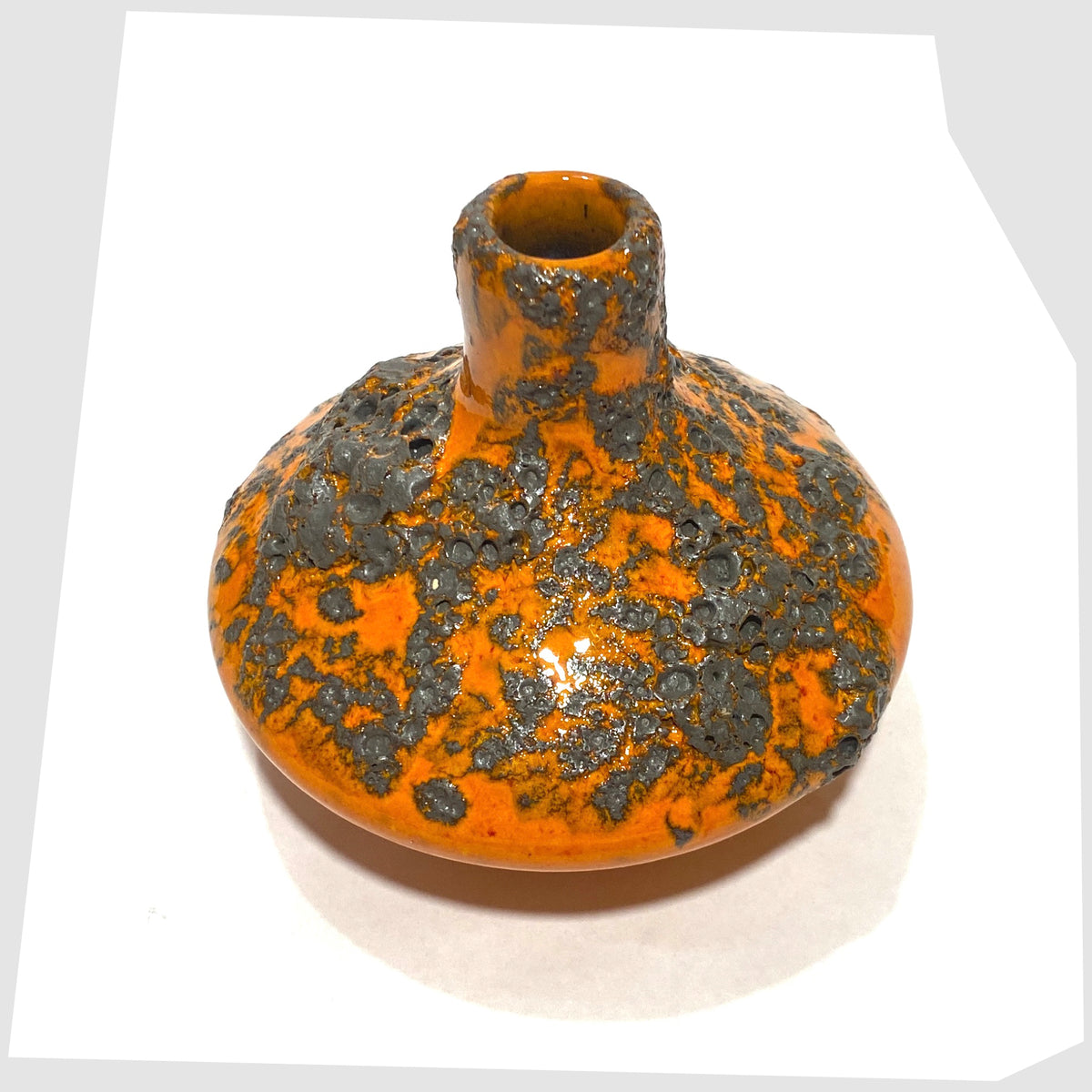 Overhead view of the Otto Keramik 206s Vase in a vibrant orange glaze with grey fat lava, shown on a white background