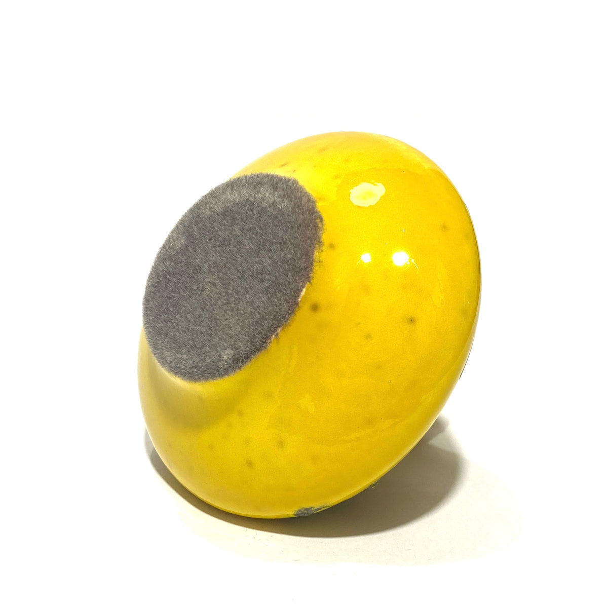 Felted base of the Otto Keramik 206s Vase in a vibrant yellow glaze with grey fat lava, shown on a white background