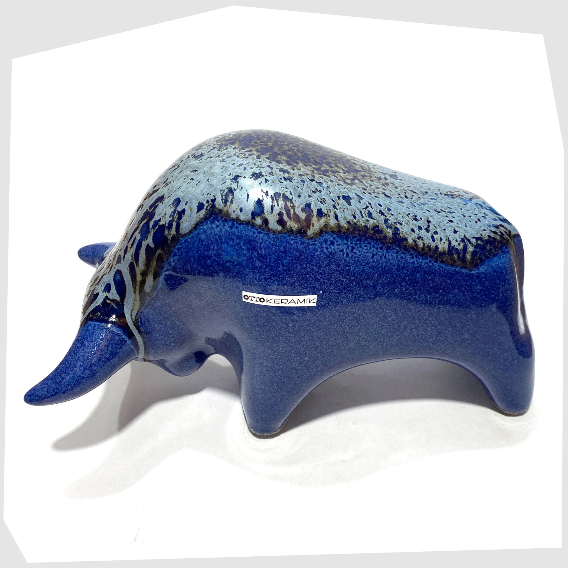 otto keramik bull in a dark blue metallic with silver bambas glaze along the spine