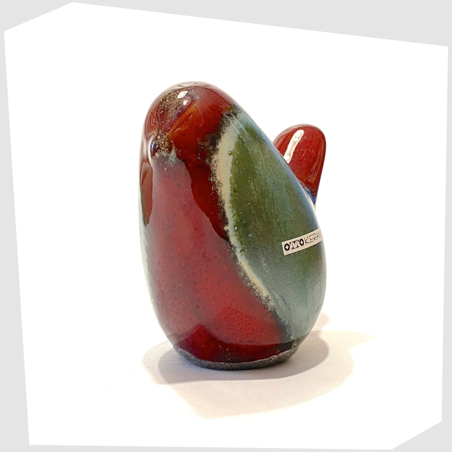 front of the otto keramik ceramic bird figurine in bolivia glaze consisting of rich red and sea green