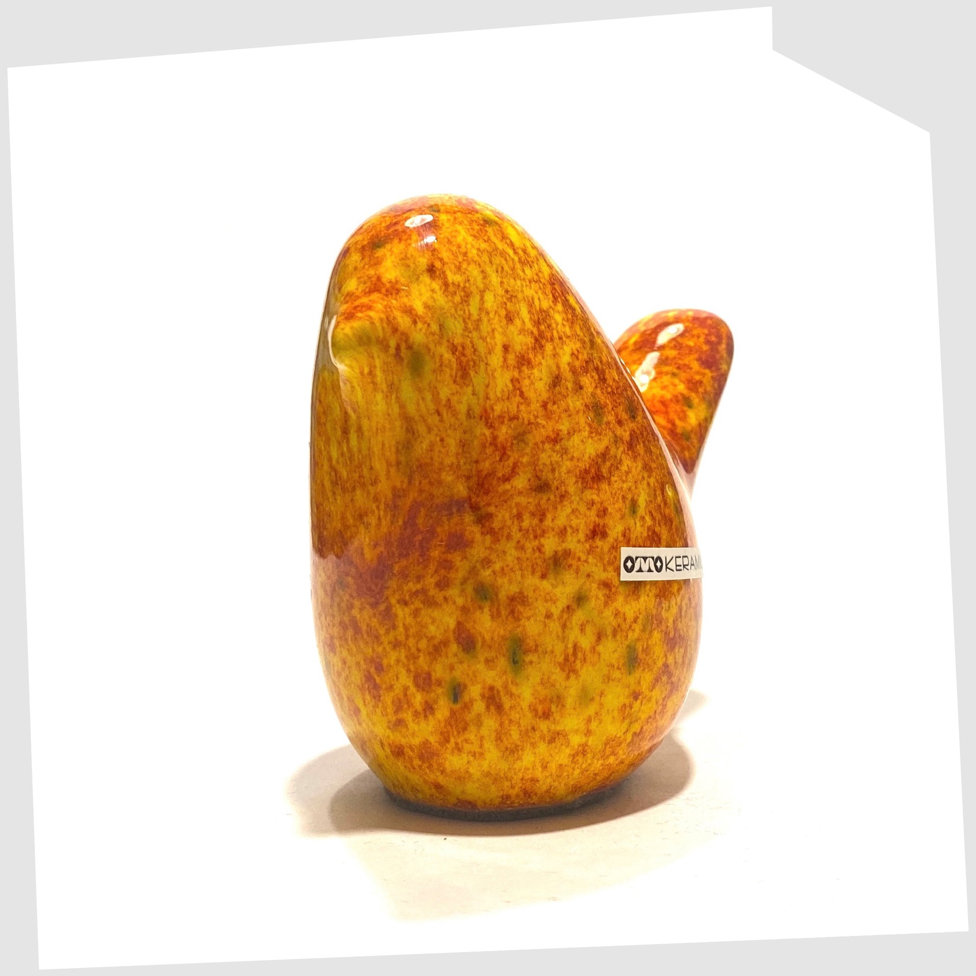 front of bird otto keramik ceramic bird in fire glaze of red, orange and yellow speckles