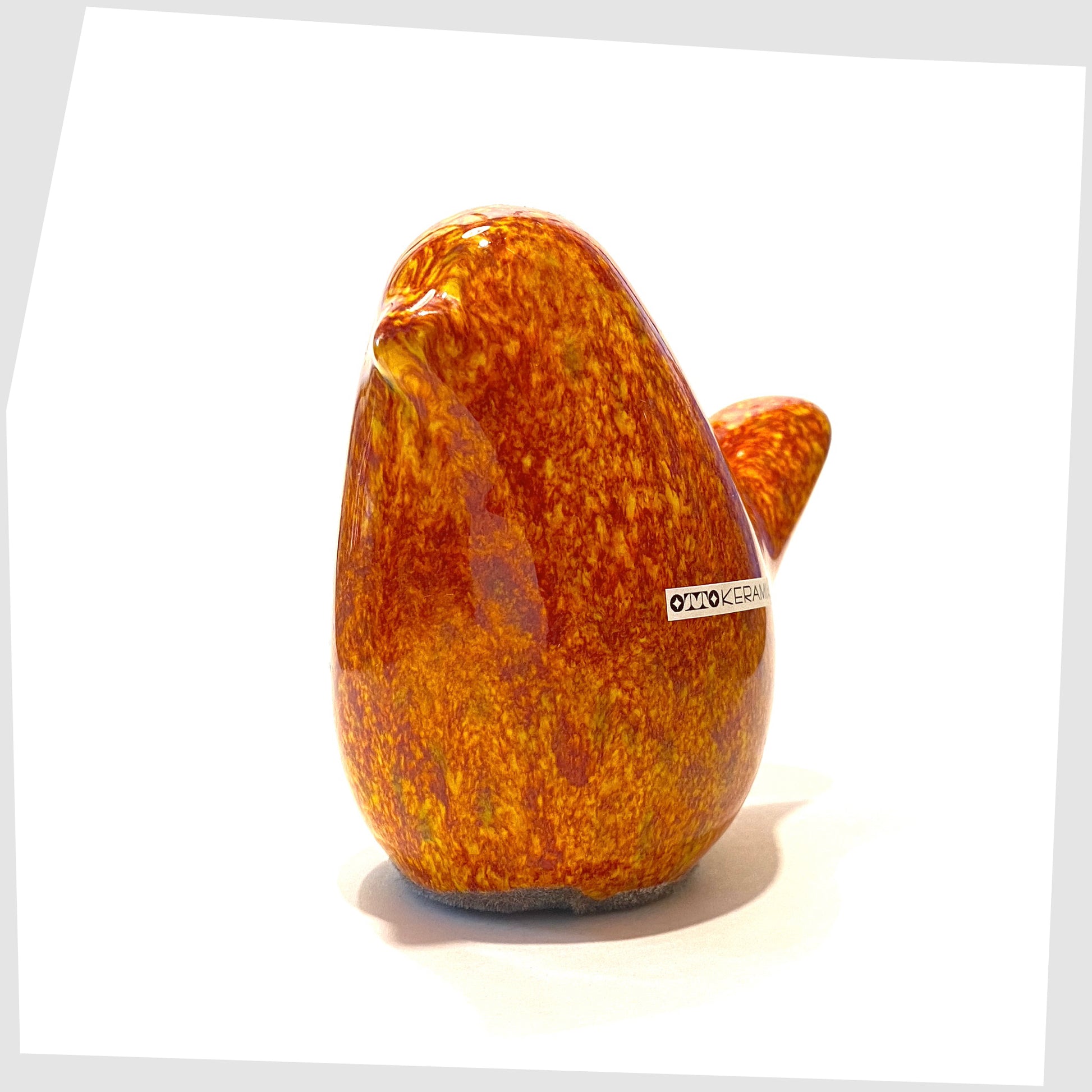 ceramic bird ornament by otto keramik in fire glaze of red, yellow and orange flecks