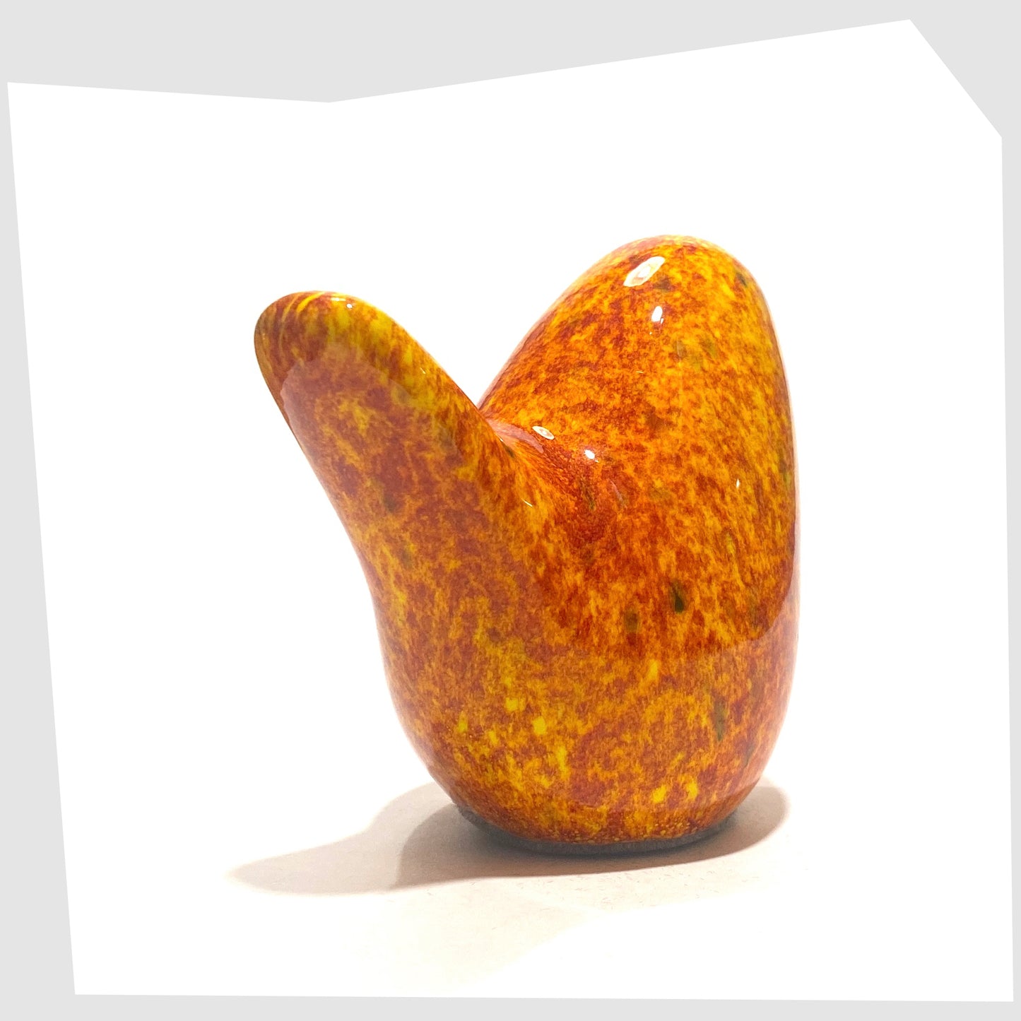 tail of the otto keramik ceramic bird in fire glaze of red, orange and yellow speckles