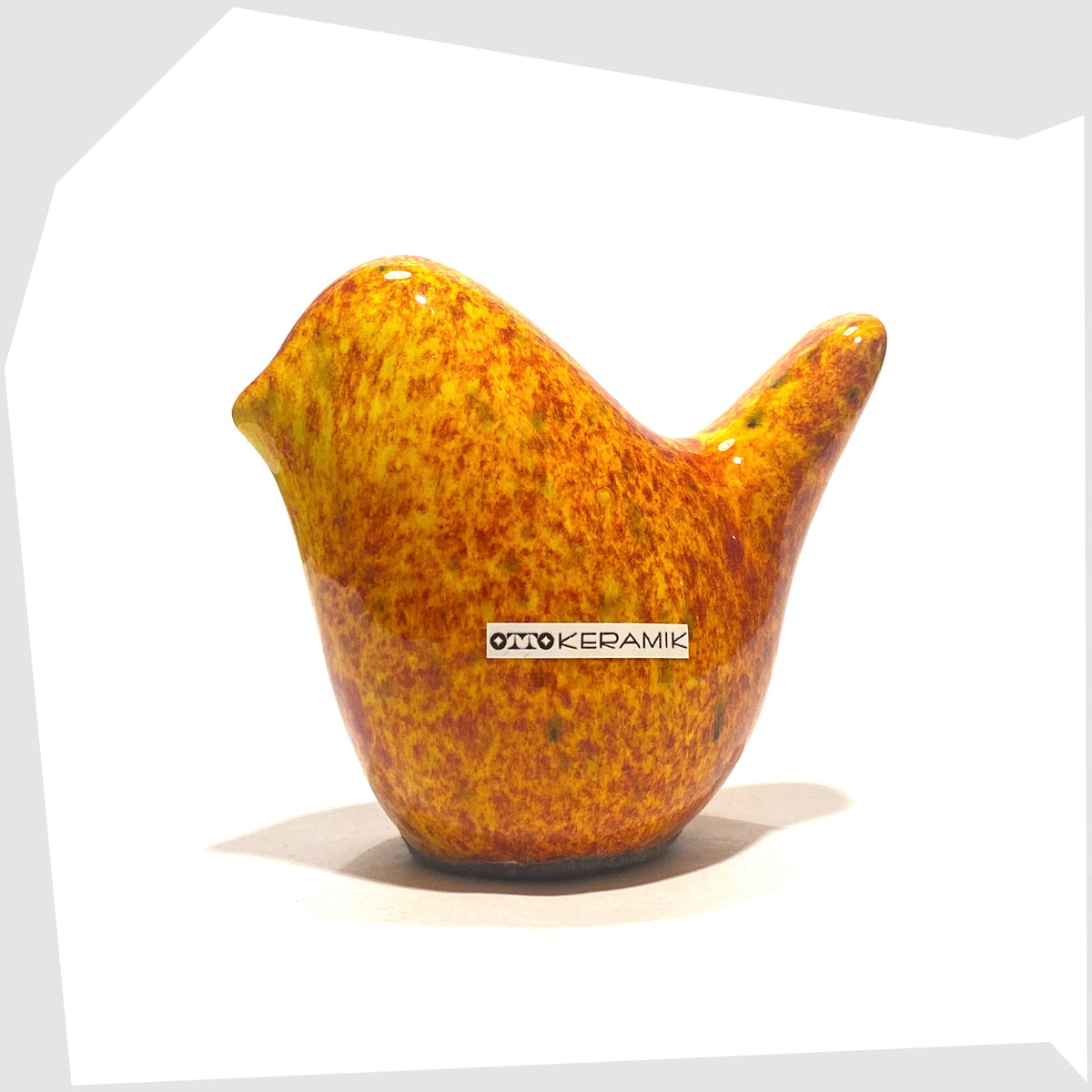 Otto Keramik Bird in Fire glaze of orange, red and yellow flecks, shown on a white background