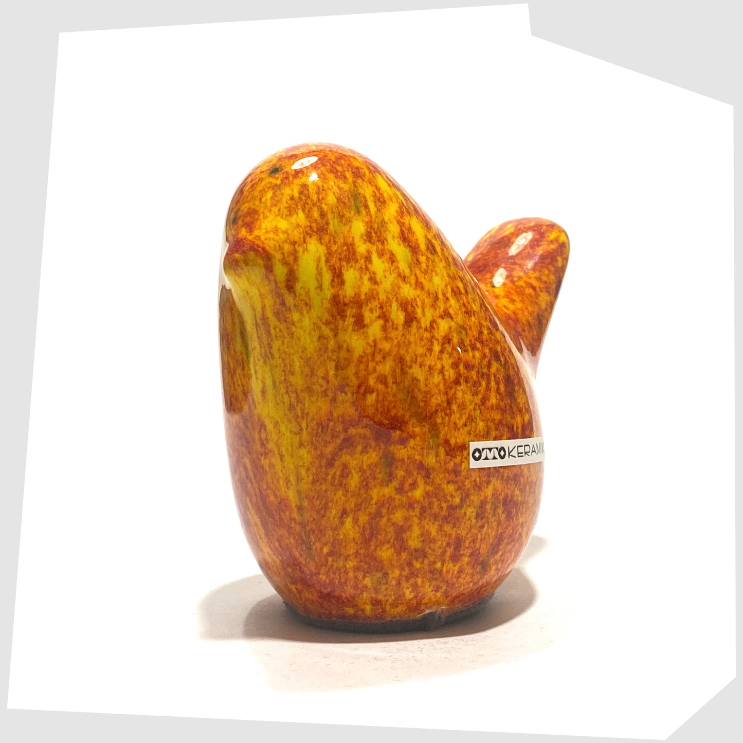 front of bird otto keramik ceramic bird in fire glaze of red, orange and yellow speckles