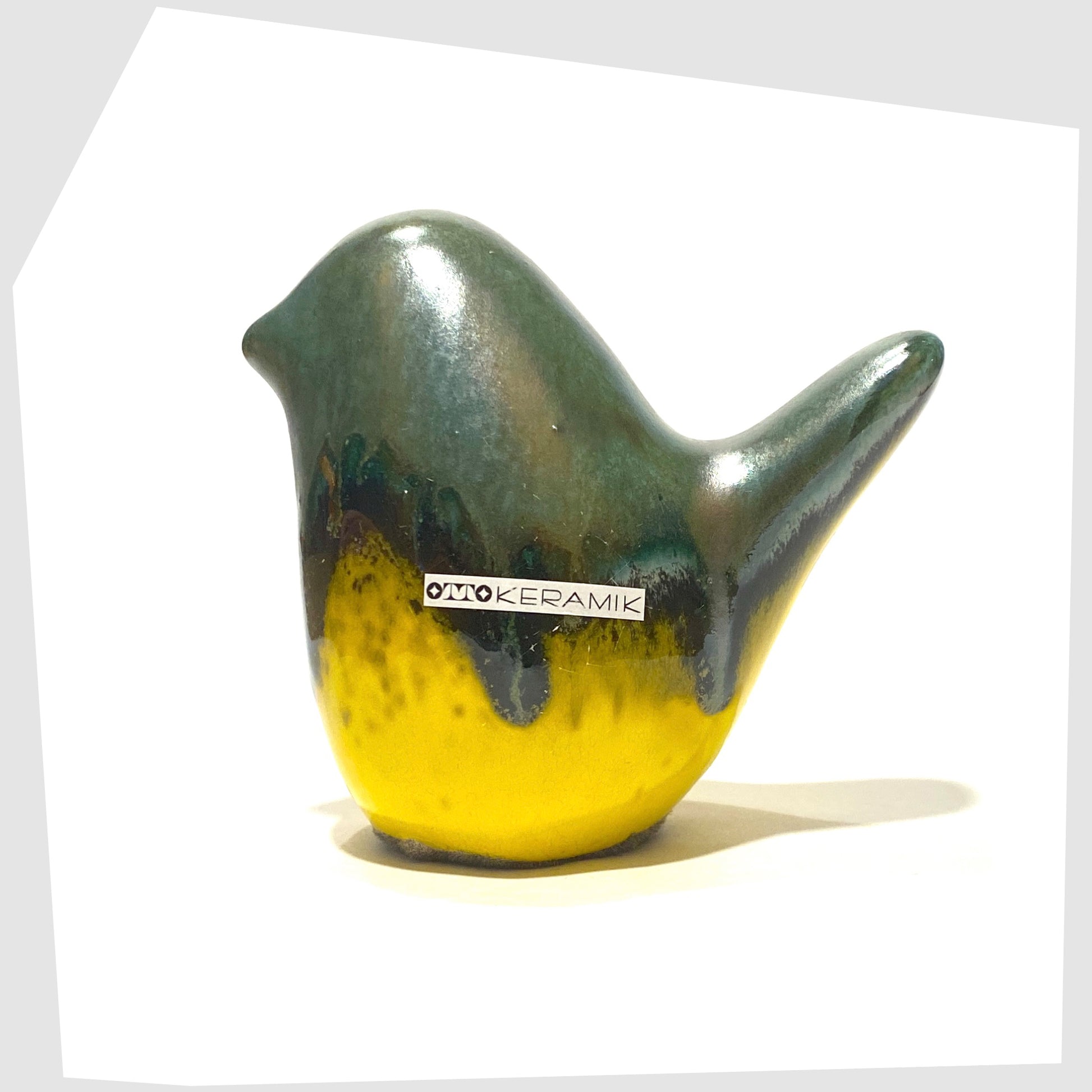 otto keramik bird sculpture in sea green drip glaze over a vibrant yellow base