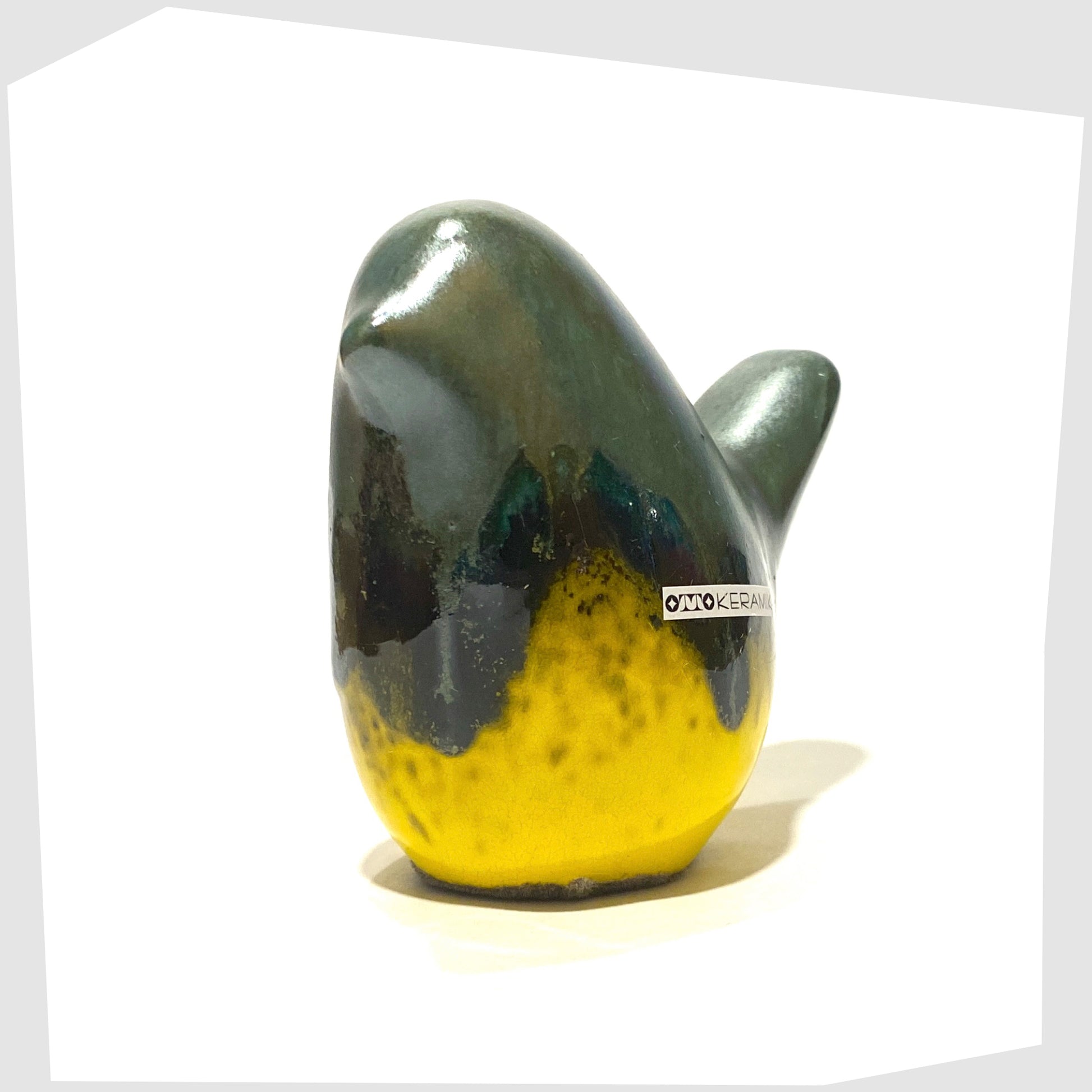 ceramic bird in sea green drip glaze over a gloss yellow base, made by otto keramik, Germany