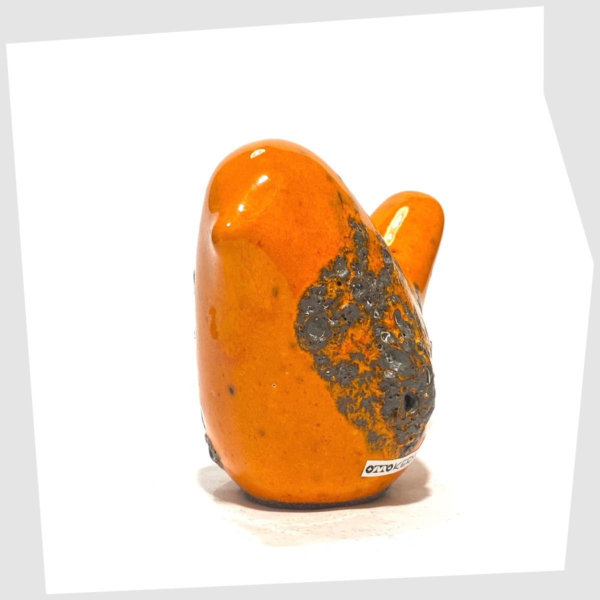 Front of the Otto Keramik Ceramic Bird in Orange Fat Lava Glaze shown on a white background