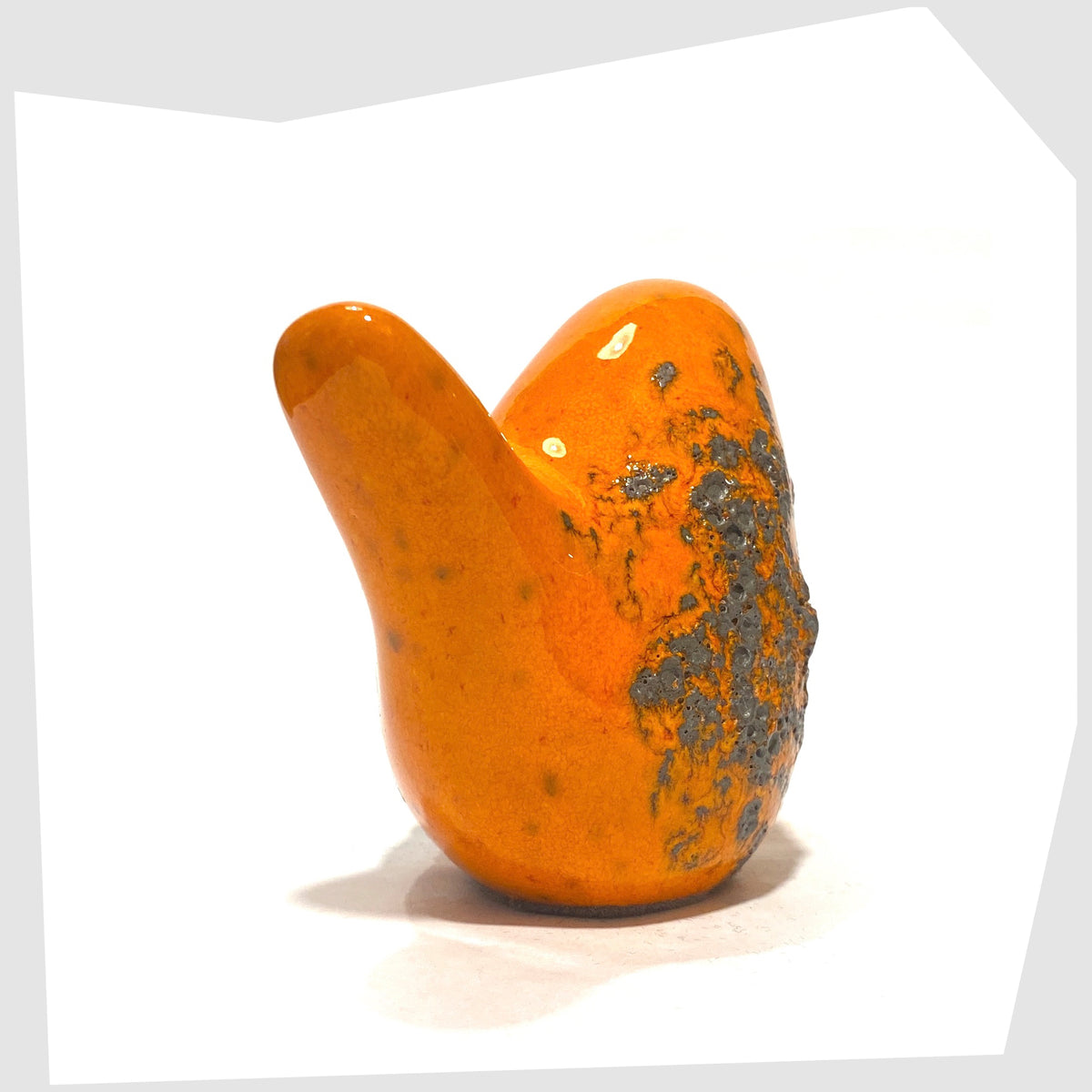 Tail of the Otto Keramik Ceramic Bird in Orange Fat Lava Glaze shown on a white background