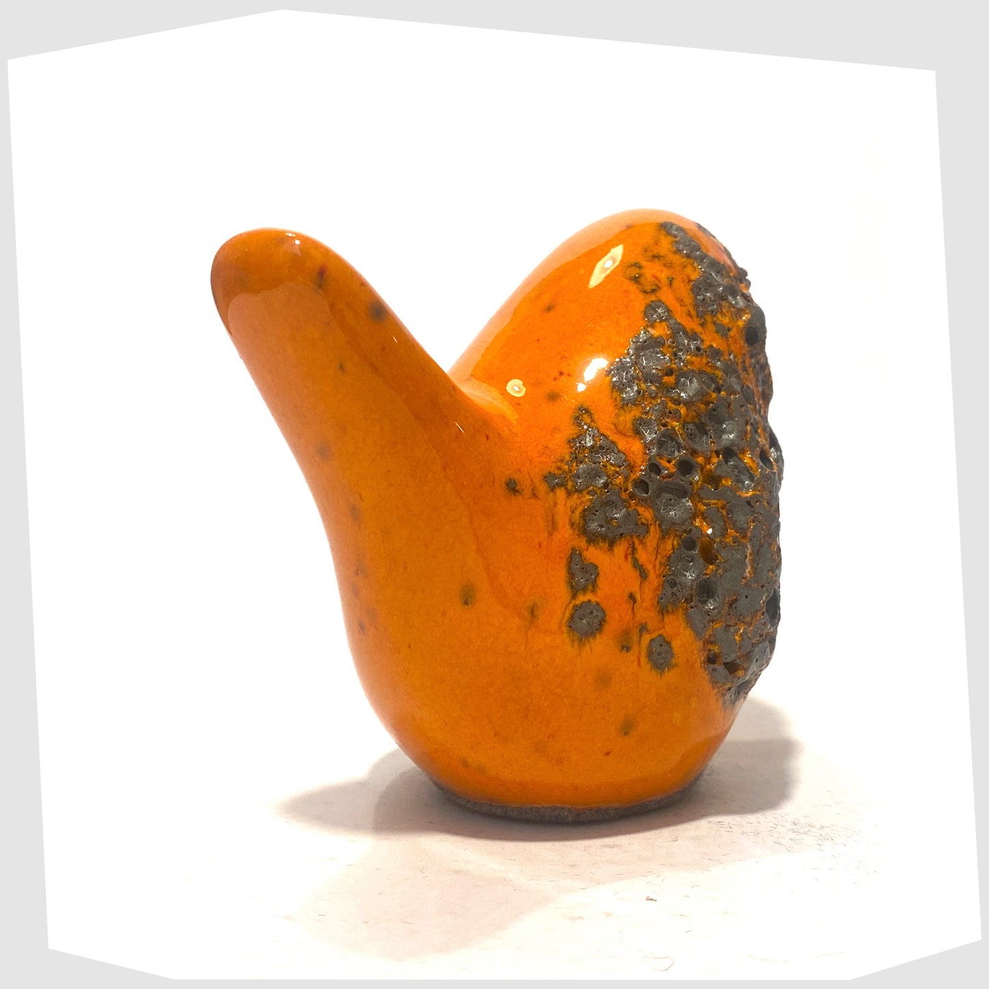 tail of the otto keramik bird in orange with fat lava glaze