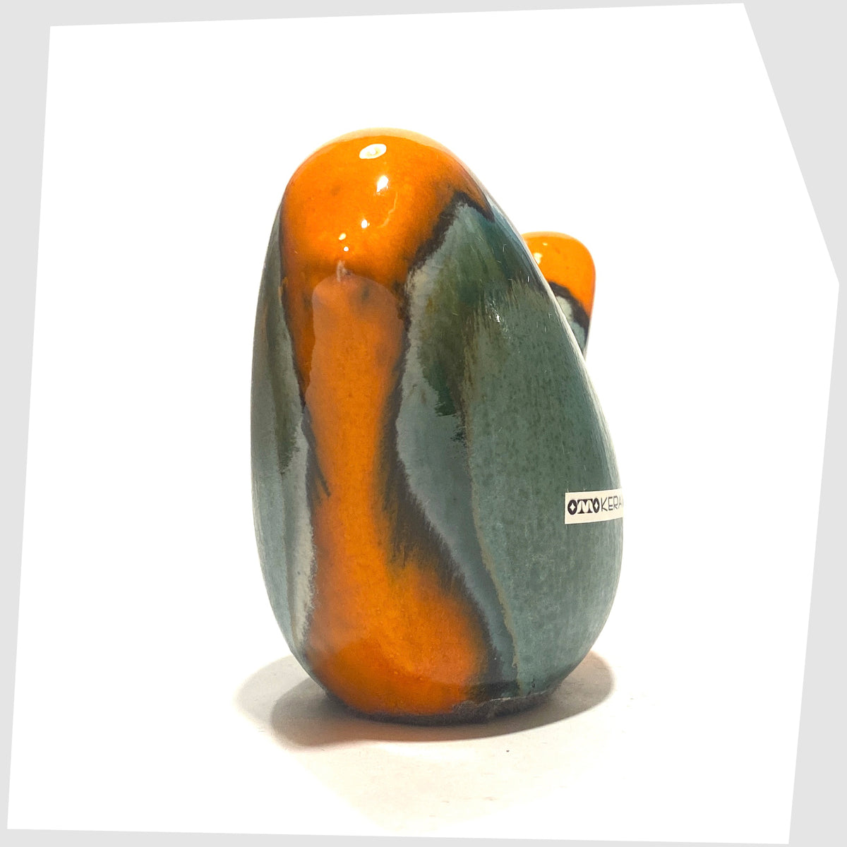 Otto Keramik Ceramic Bird in Peru glaze of orange with sea green drip glaze, shown on a white background