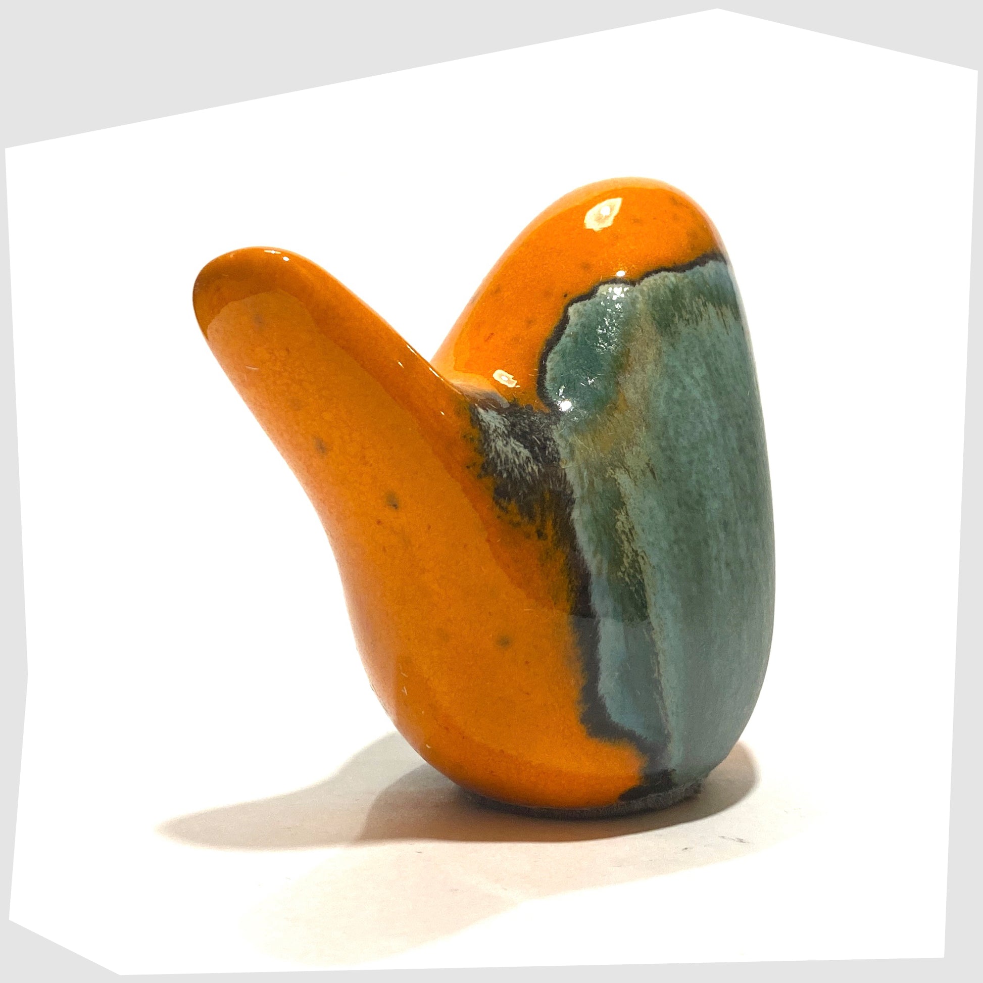 tail of the ceramic bird in peru glaze of orange and sea green by otto keramik, germany