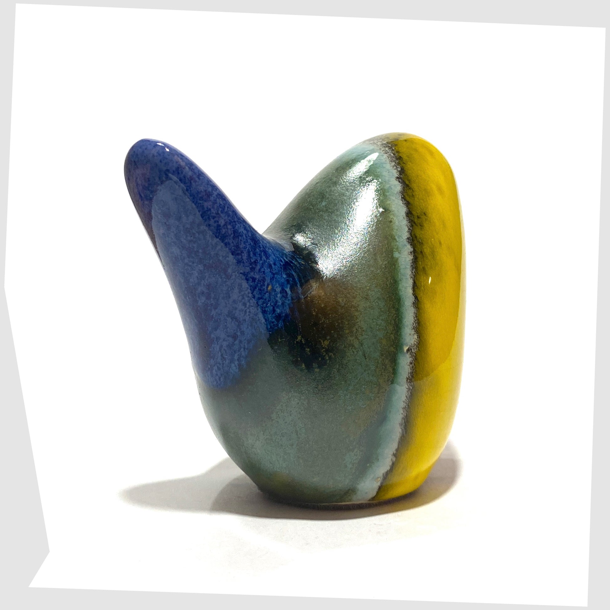west german pottery-style ceramic bird in rainbow coloured glaze by otto keramik, tail angled view