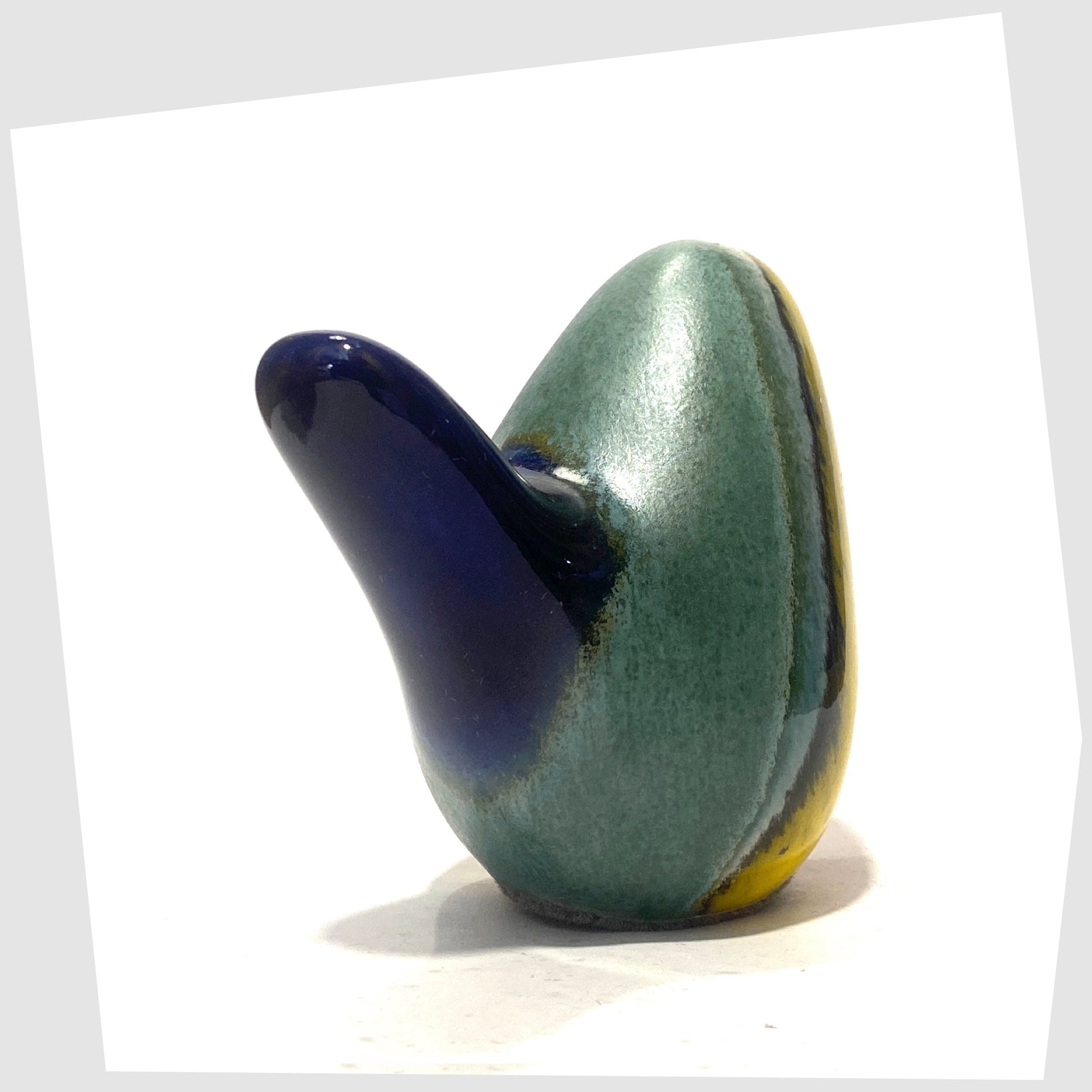 west german pottery-style ceramic bird in rainbow coloured glaze by otto keramik, tail angled view, shown on a white background