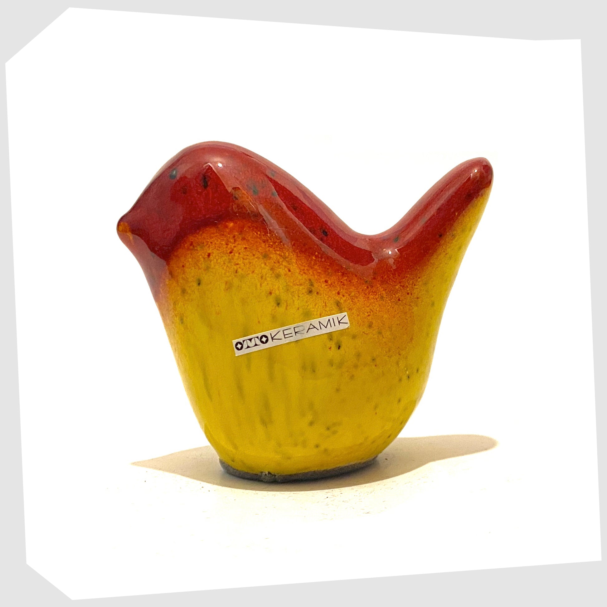 otto-keramik-bird-in-red-over-yellow-drip-glaze