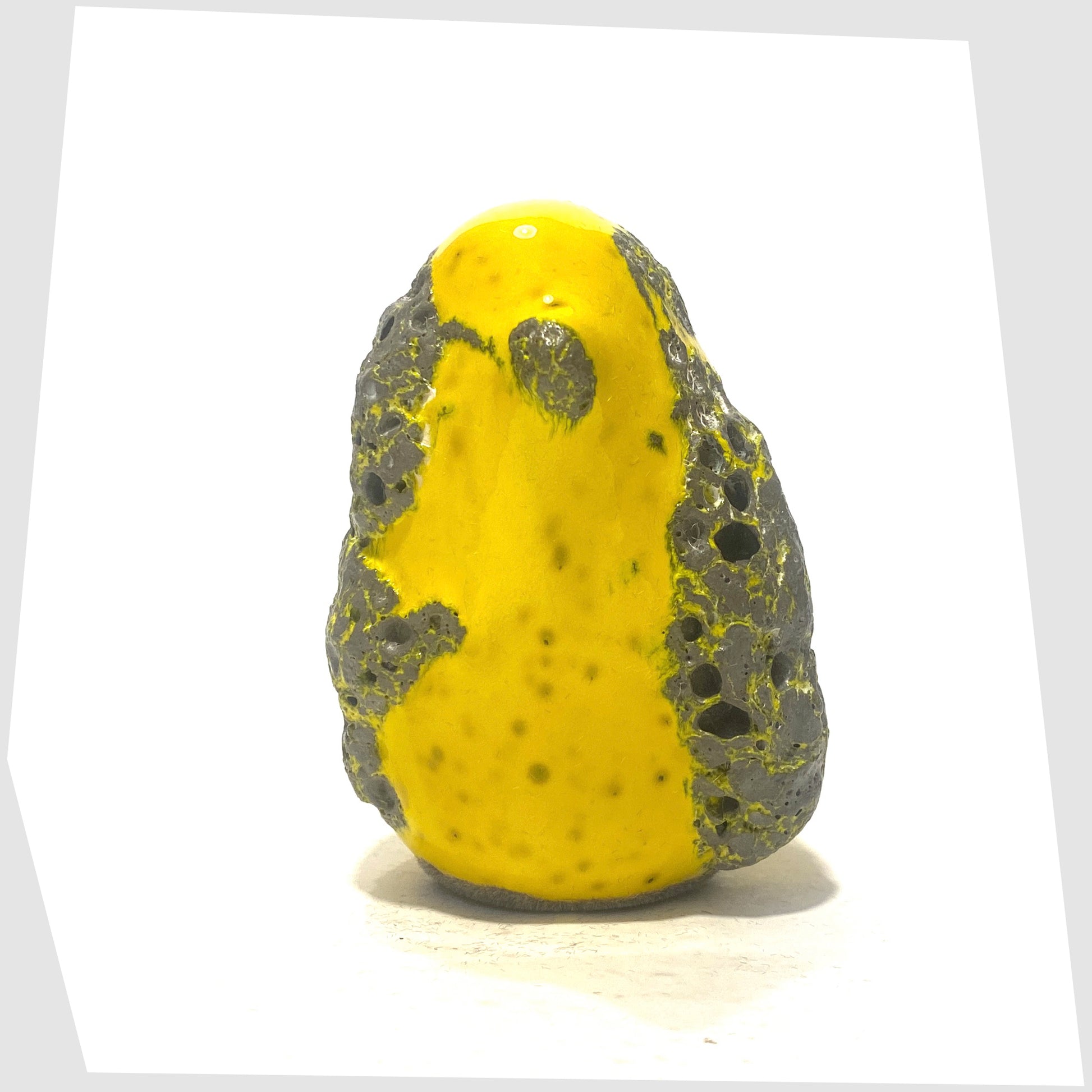 front of the otto keramik ceramic bird sculpture in yellow with grey fat lava glaze