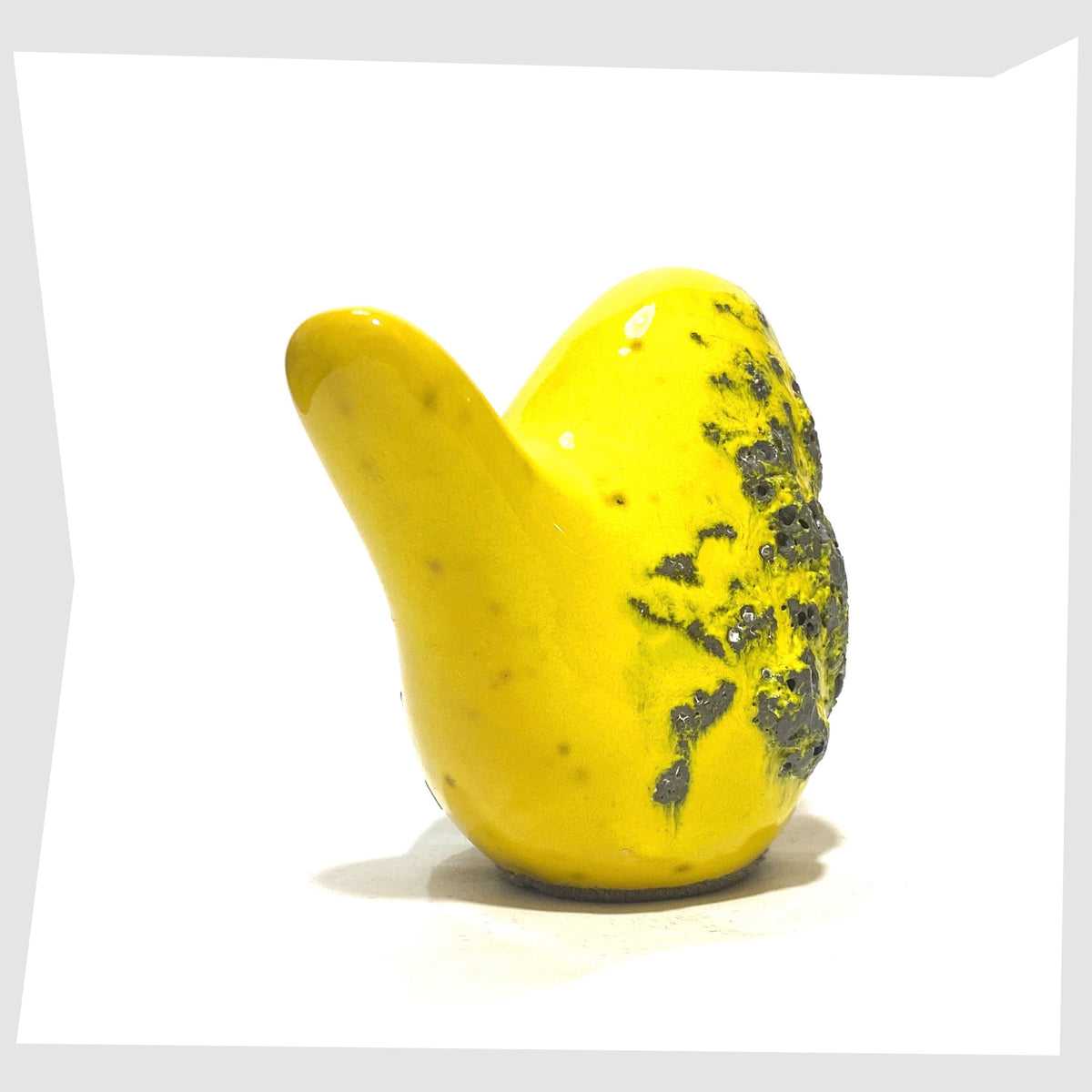 Rear tail of the Otto Keramik Bird in yellow fat lava glaze, shown on a white background