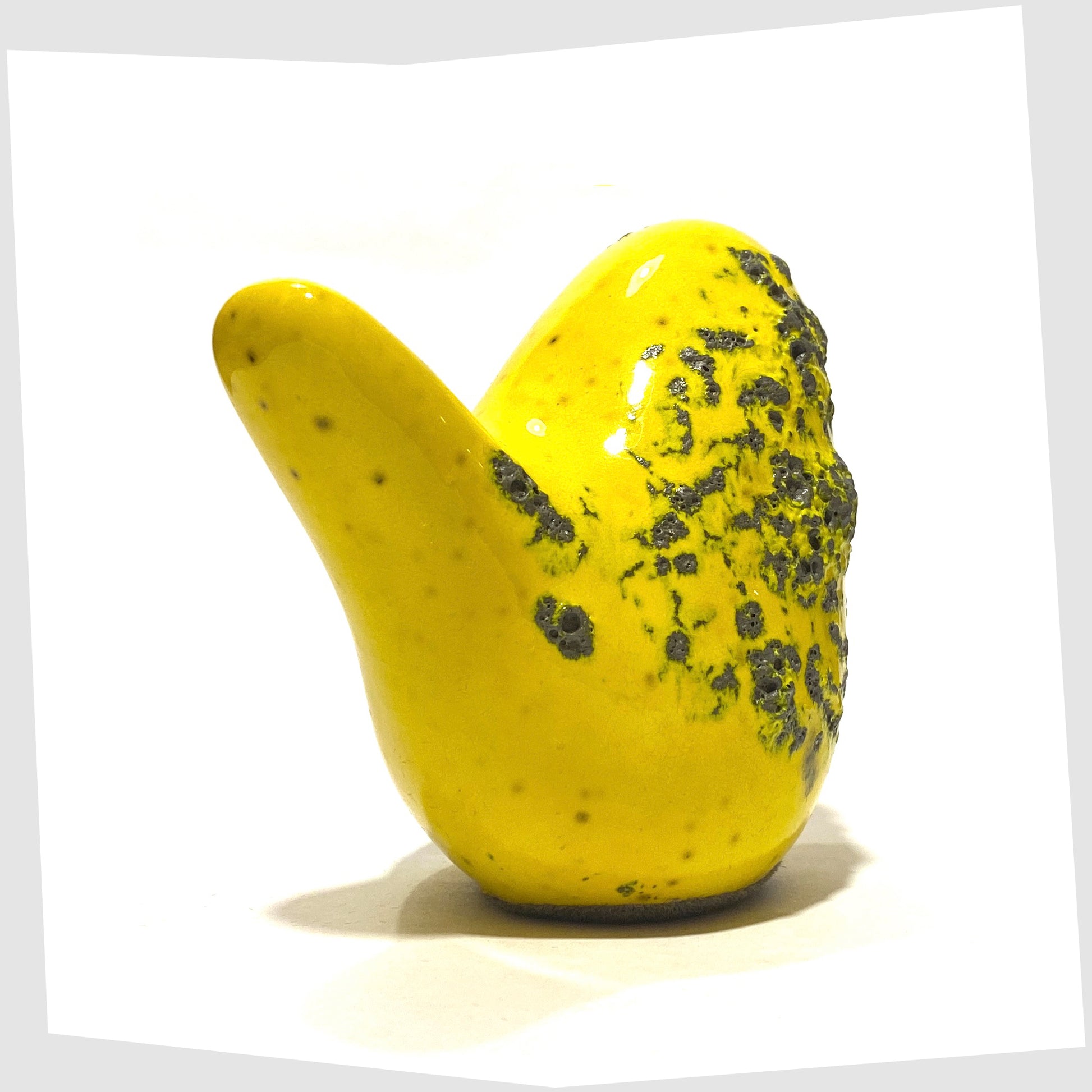 tail of the otto keramik ceramic bird sculpture in yellow with grey fat lava glaze