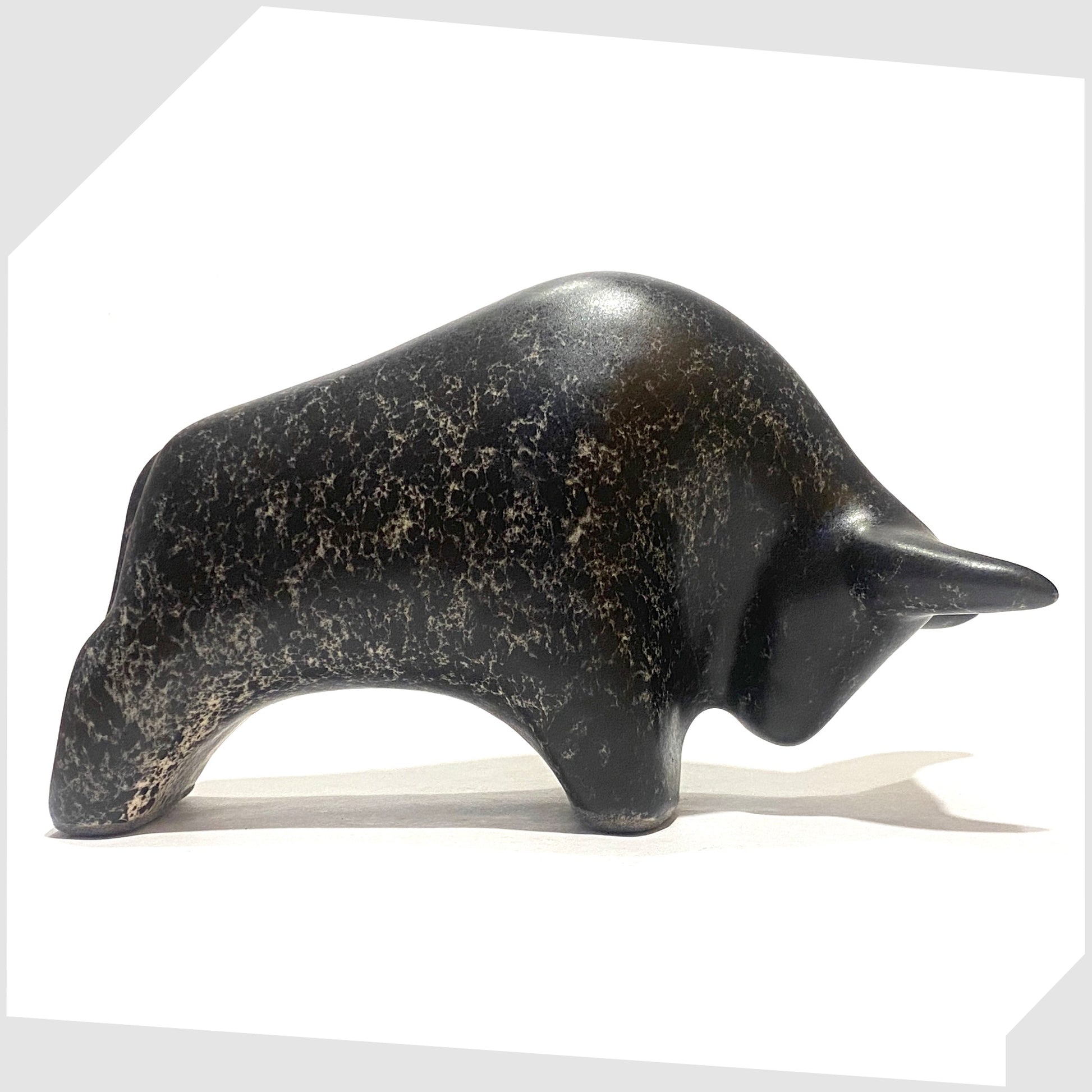 West German Pottery-inspired Otto Keramik ceramic bull-shaped figurine in black speckled glaze, shown on a white background