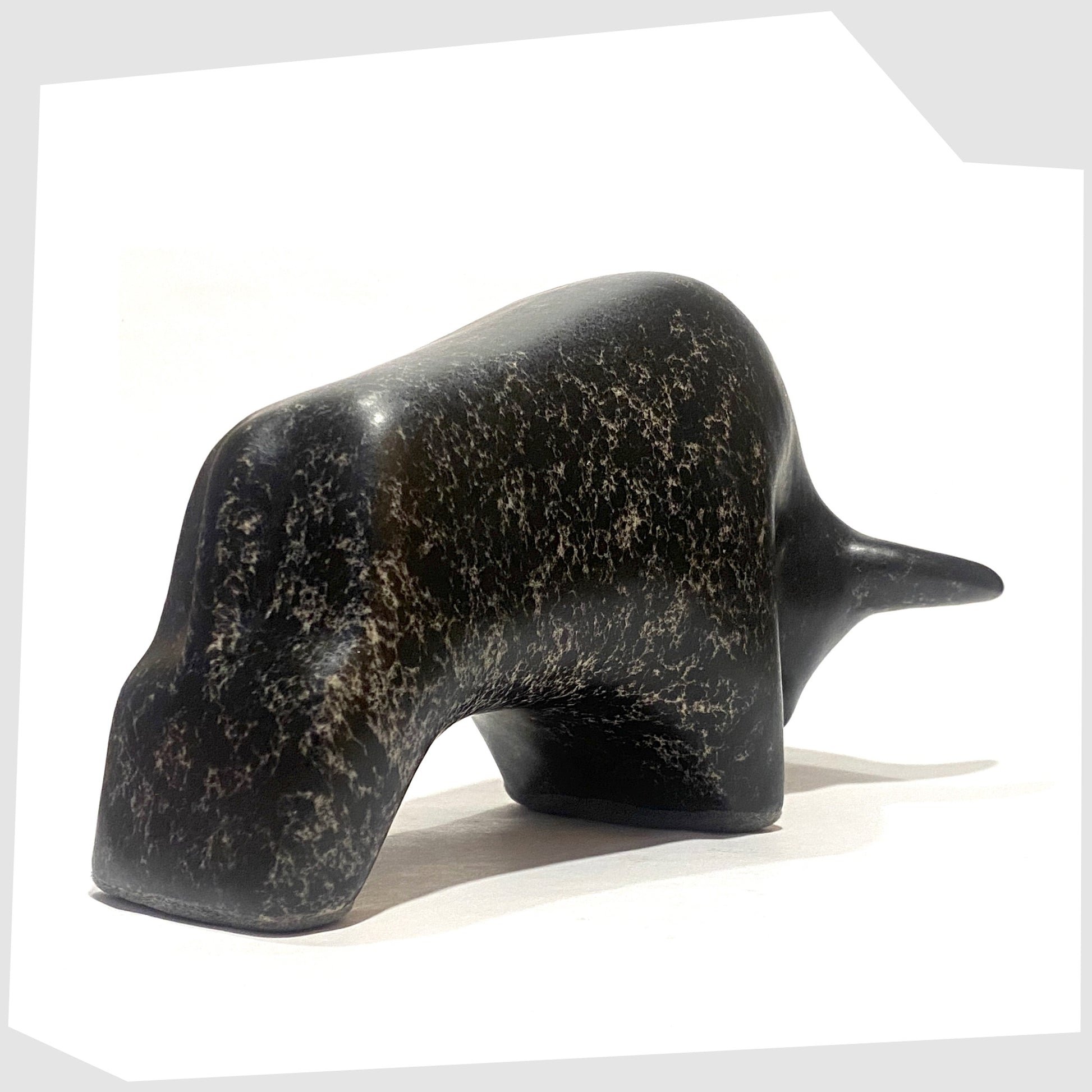 Rear of the Otto Keramik ceramic bull-shaped figurine in black speckled glaze, shown on a white background