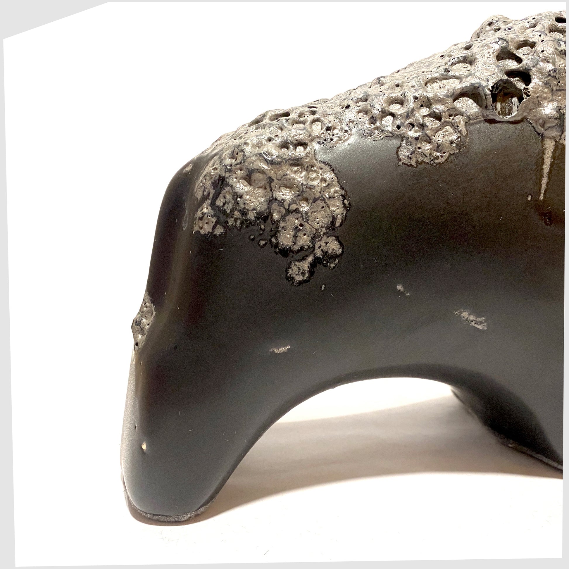 back of the otto keramik bull in matte black with a textured band of fat lava glaze