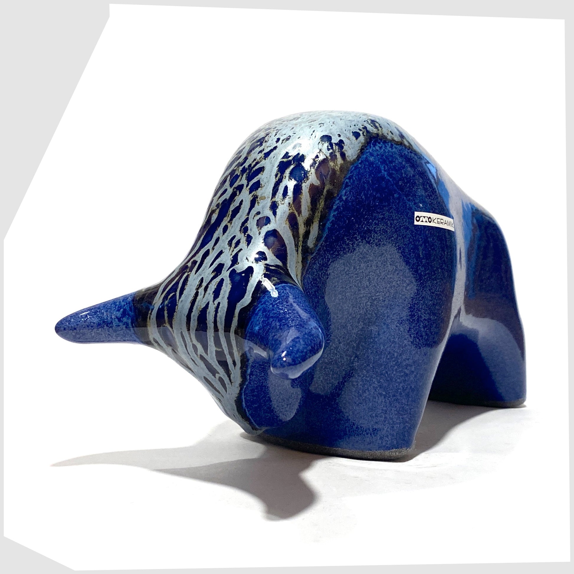 otto keramik ceramic bull-shaped ornament in a dark blue metallic with silver bambas glaze along the spine