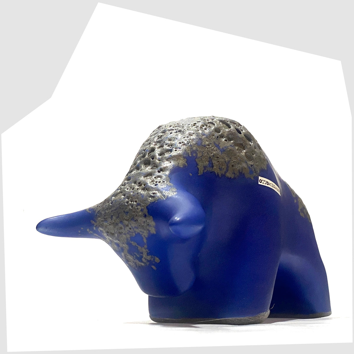 Front horns of the Otto Keramik Bull-shaped ceramic ornament in blue with grey fat lava glaze, shown on a white background