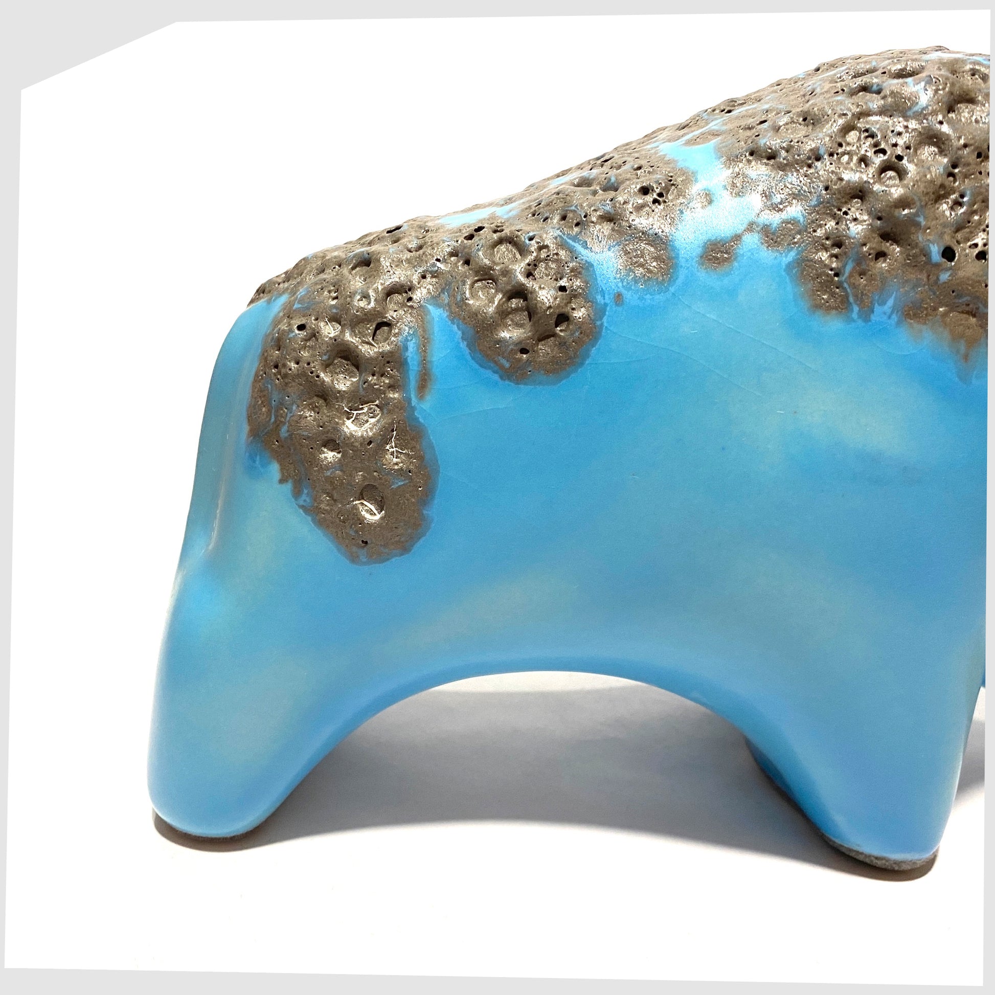 close up of the otto keramik bull in light blue glaze with grey fat lava