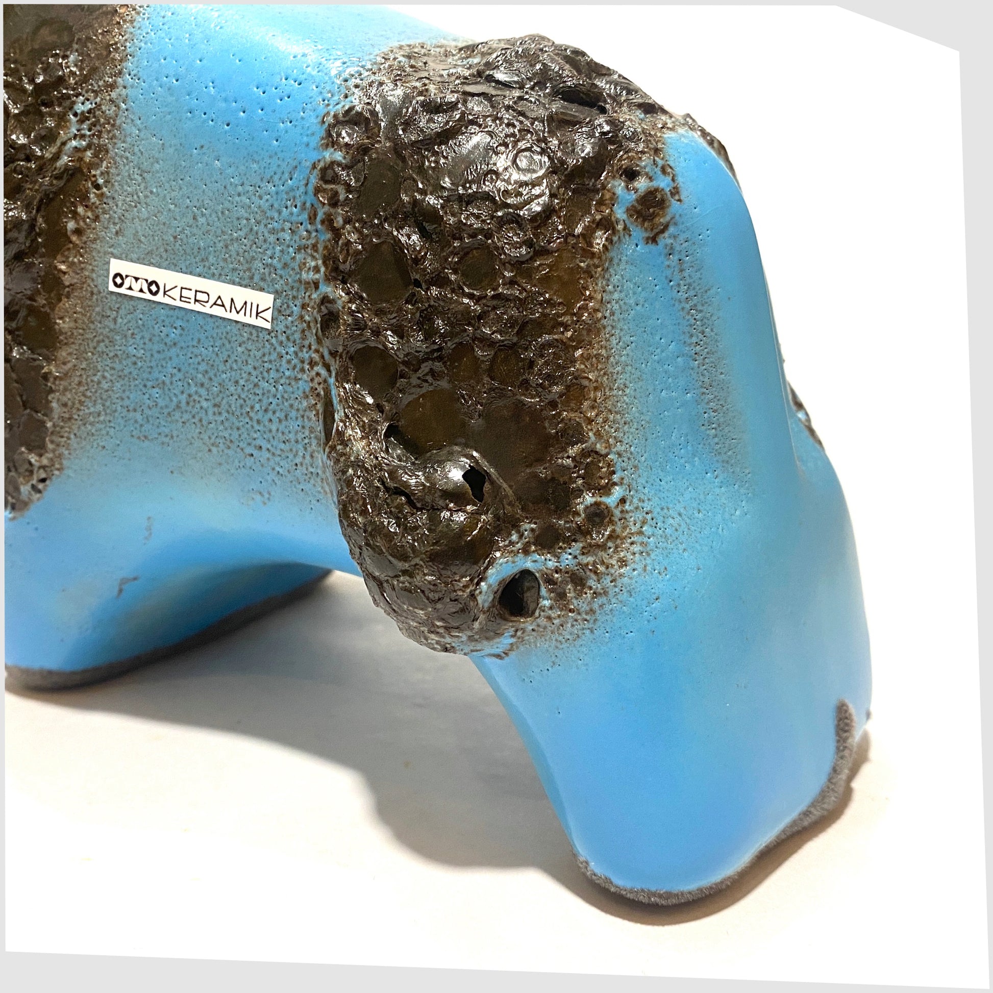 back of the otto keramik bull in light blue glaze with striped of deep fat lava glaze