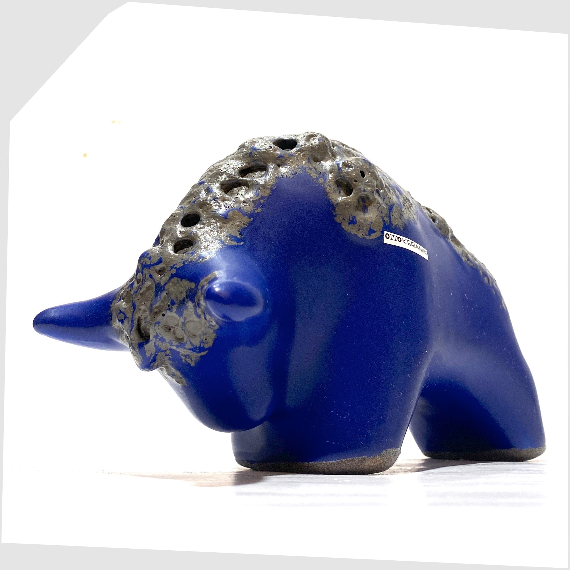 Front horns of the Otto Keramik bull in blue glaze with deep textured fat lava glaze along the spine