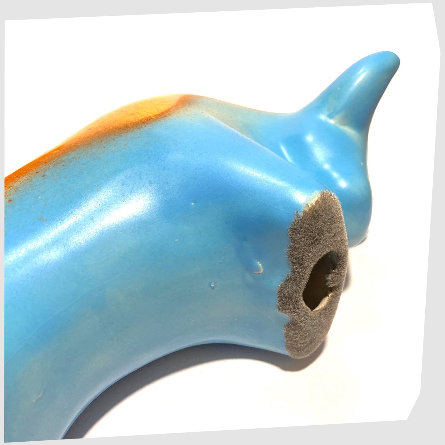 underside of the otto keramik bull in orange over blue glaze