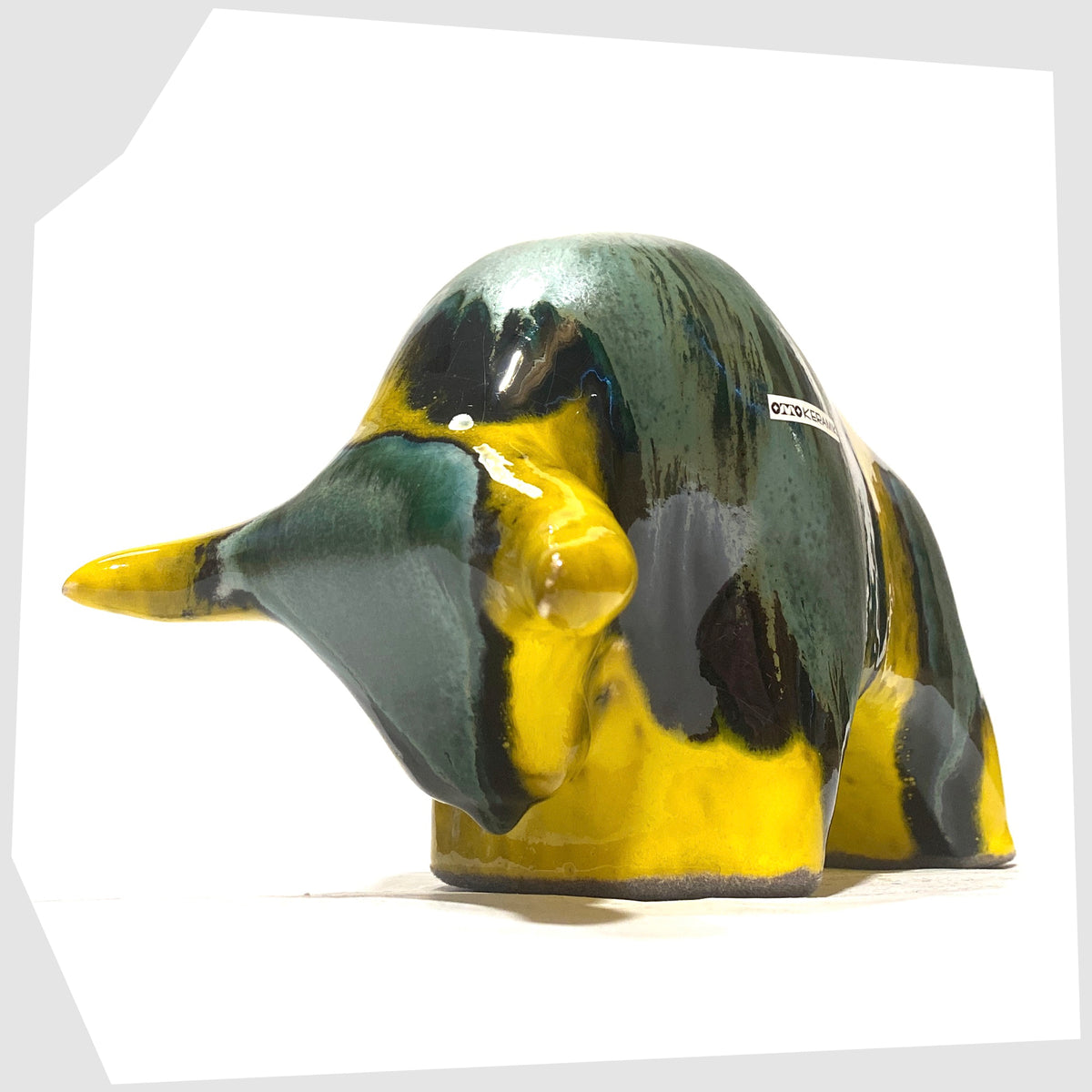 Horns of the Otto Keramik Ceramic Bull in Brazil Glaze of yellow and sea green stripes, shown on a white background