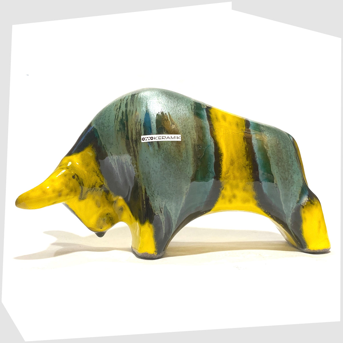Otto Keramik Ceramic Bull in Brazil Glaze of yellow and sea green stripes, shown on a white background