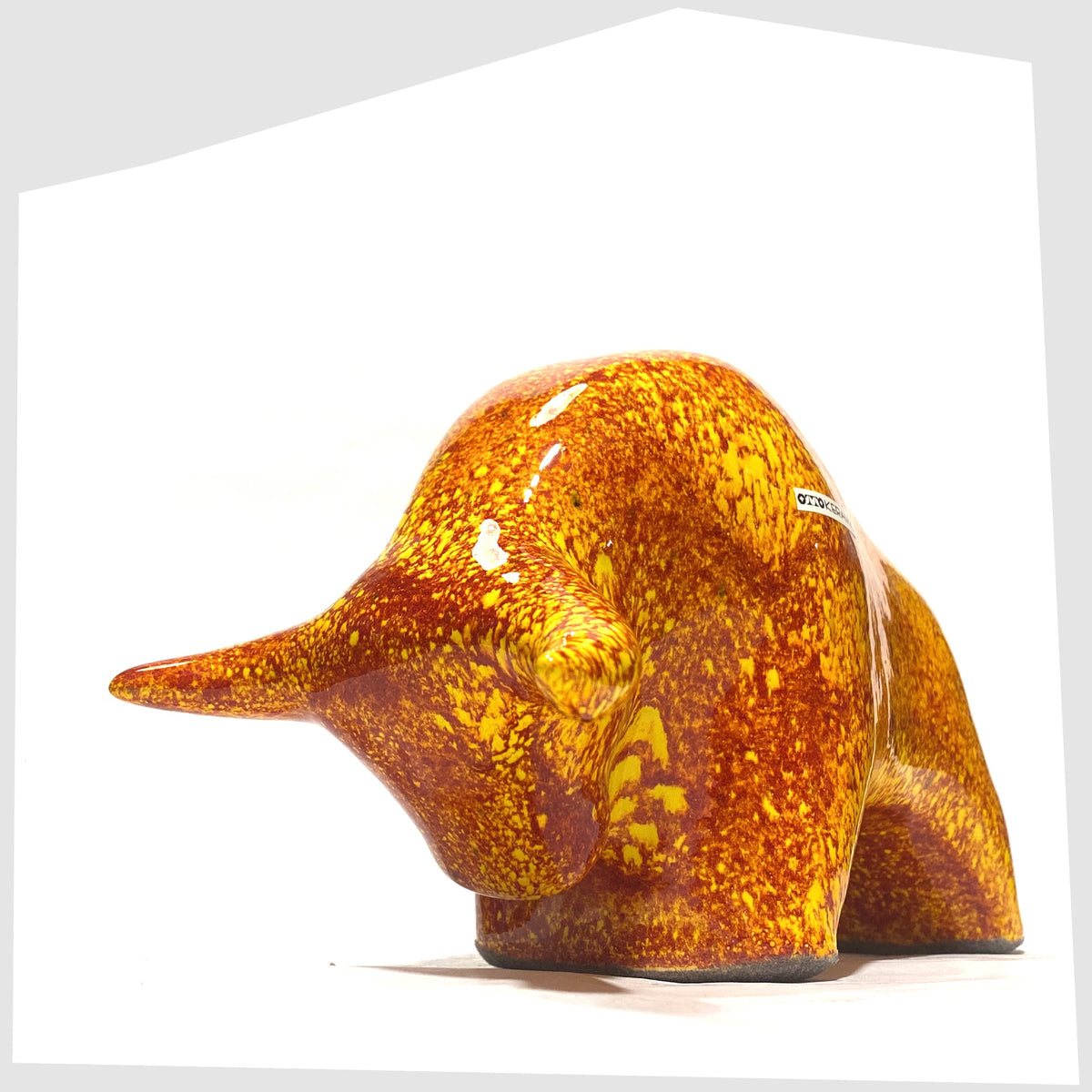Front horns of the Otto Keramik Bull in fire glaze of red, orange and yellow flecks, shown on a white background