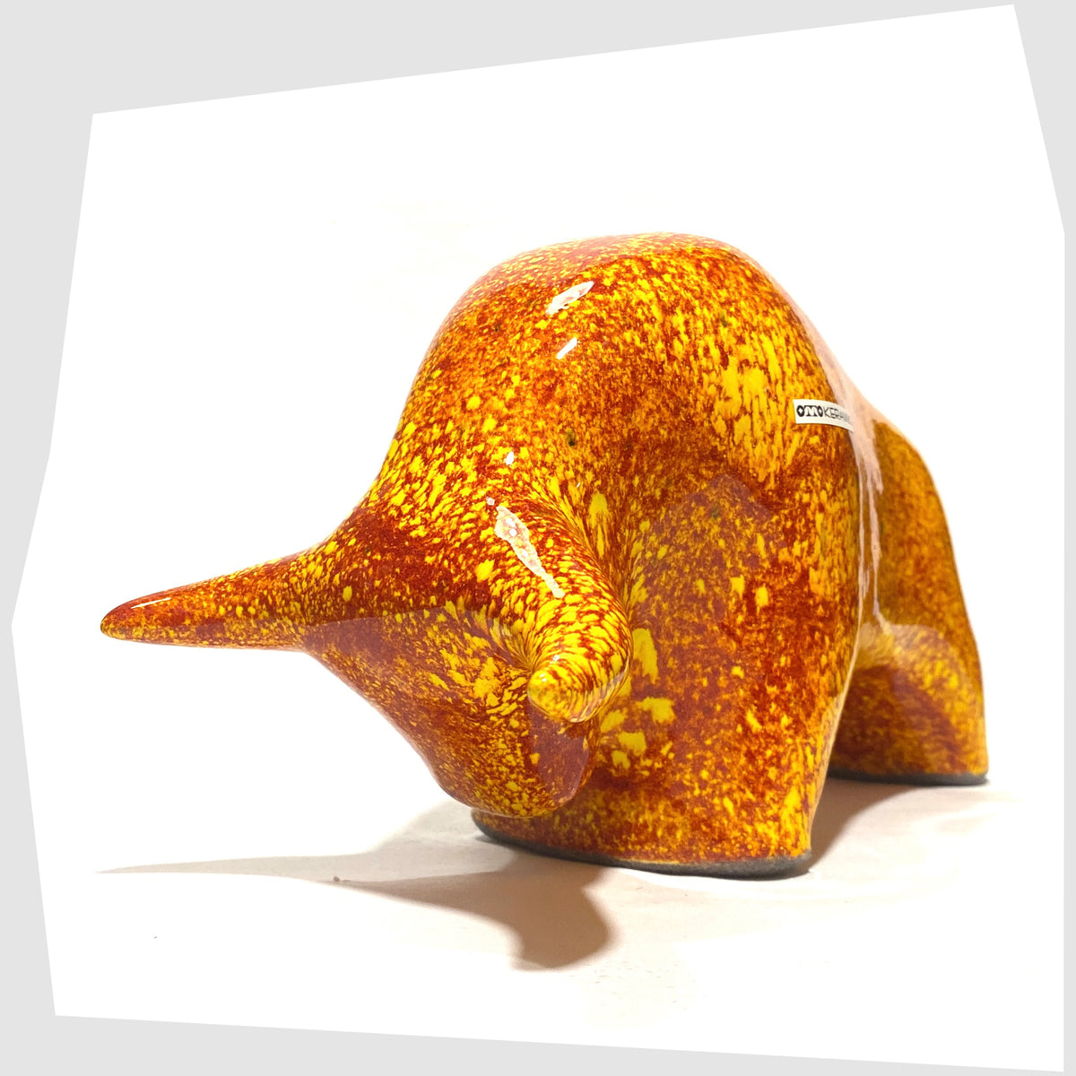 Otto Keramik Ceramic Bull in fire glaze of red, orange and yellow flecks, shown on a white background