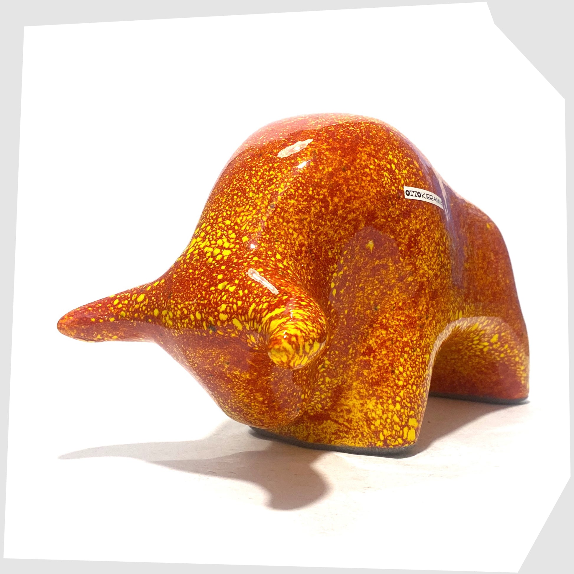 front of the otto keramik ceramic bull in fire glaze of red, orange and yellow flecks