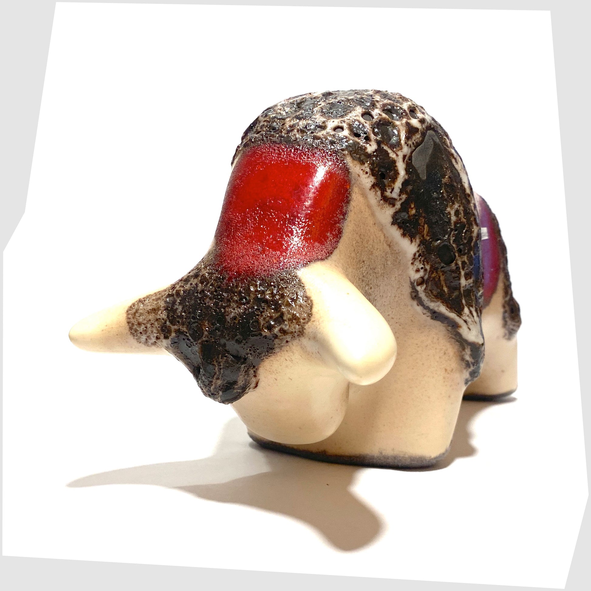 front horns of the otto keramik ceramic bull shaped ornament in the red garnet glaze with stripes of deep fat lava