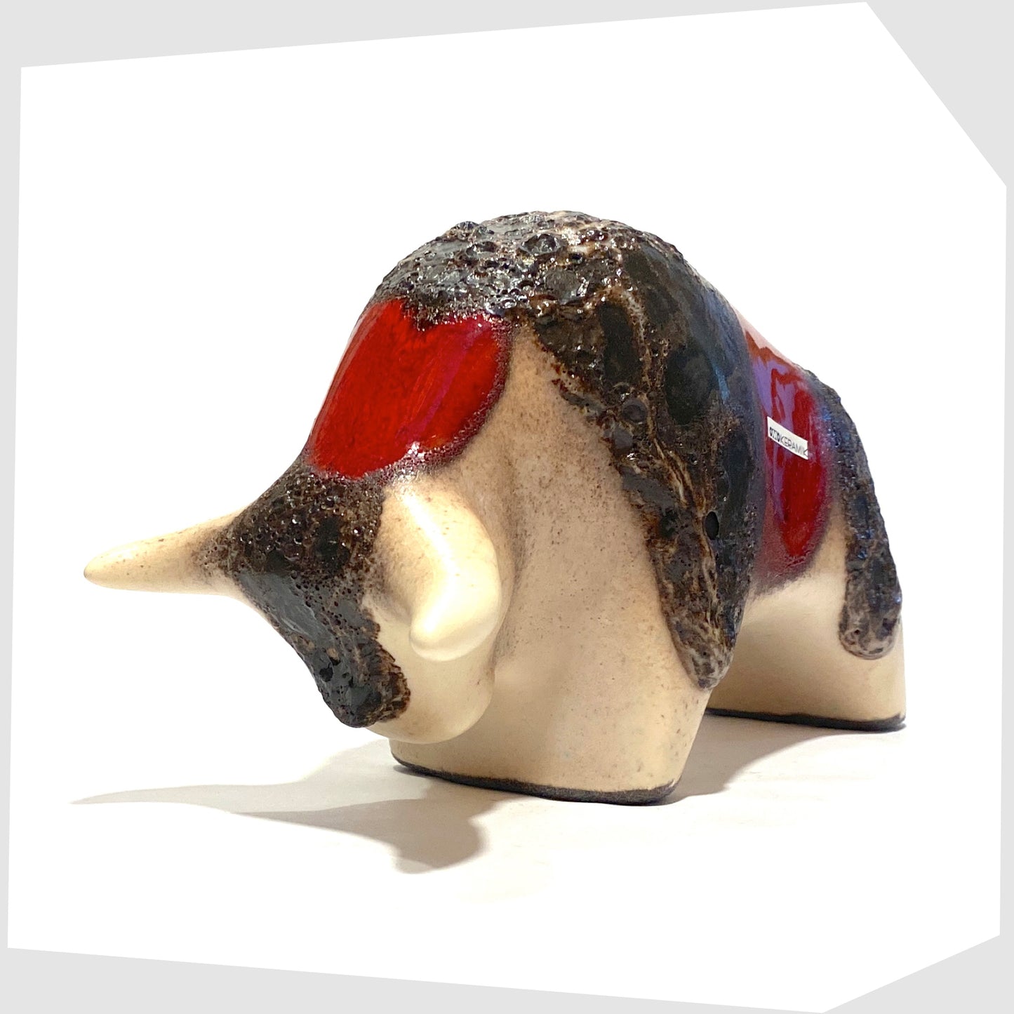 front horns of the otto keramik ceramic bull shaped ornament in the red garnet glaze with stripes of deep fat lava