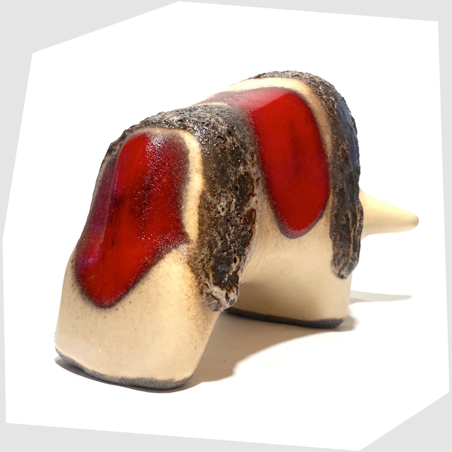 rear of the otto keramik ceramic bull shaped ornament in the red garnet glaze with stripes of deep fat lava