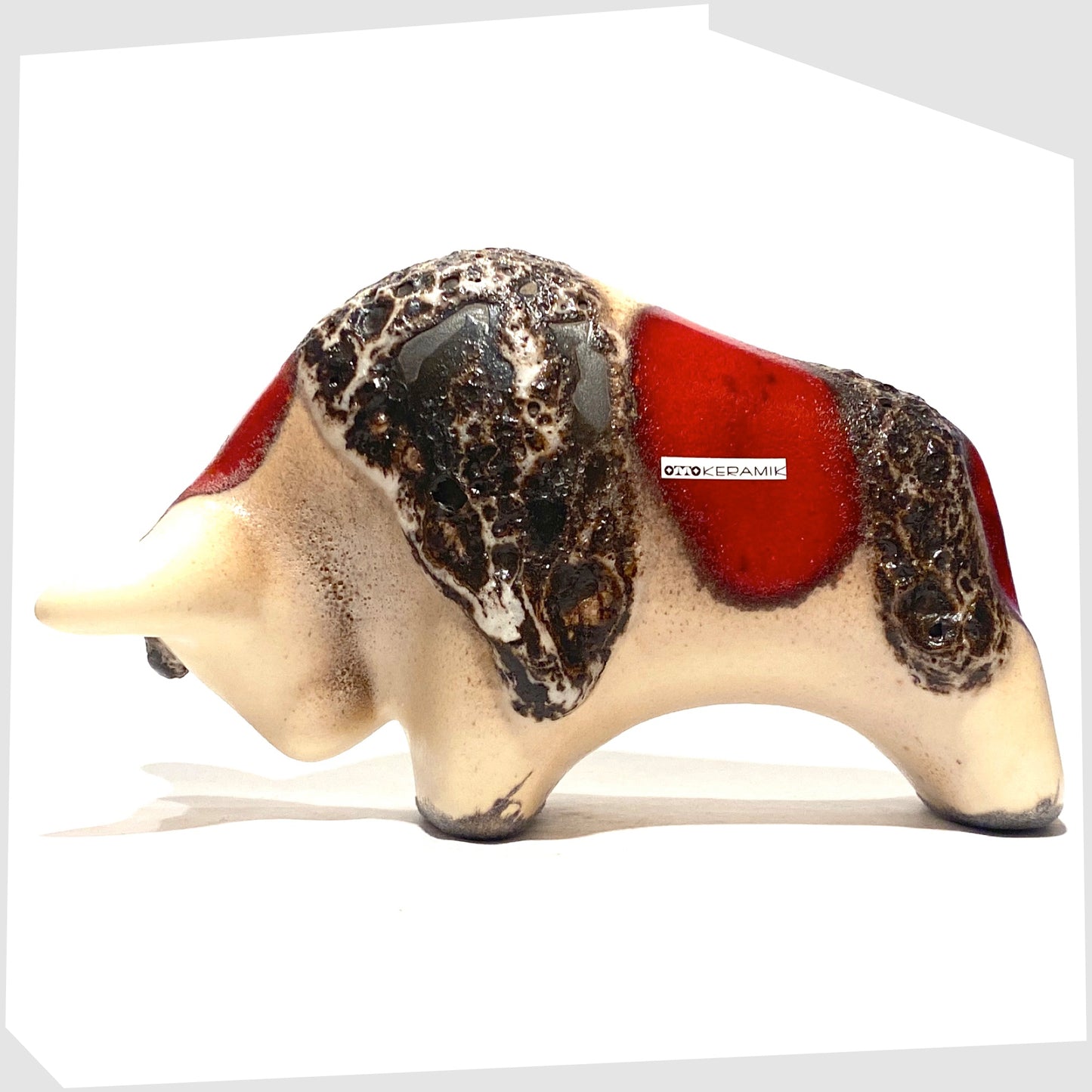otto keramik ceramic bull shaped ornament in the red garnet glaze with stripes of deep fat lava