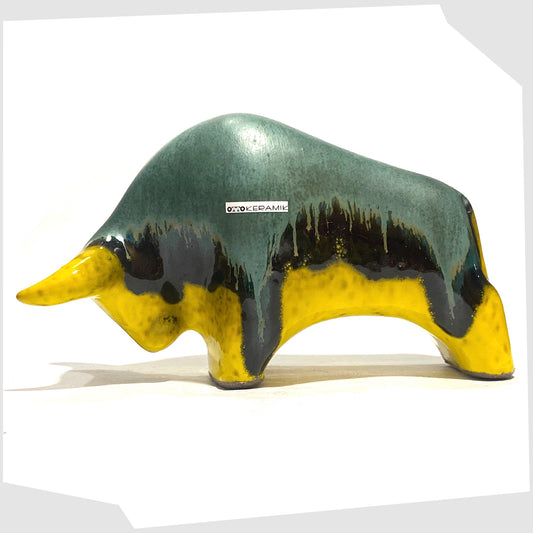 Otto Keramik ceramic bull-shaped sculpture in green over yellow drip glaze, shown on a white background