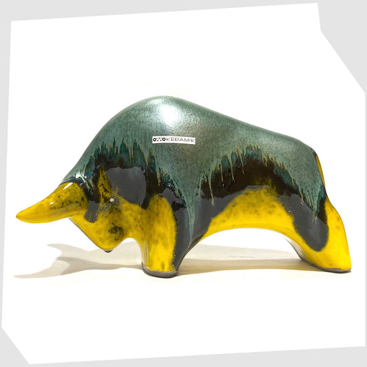 Otto Keramik ceramic bull-shaped sculpture in green over yellow drip glaze, shown on a white background