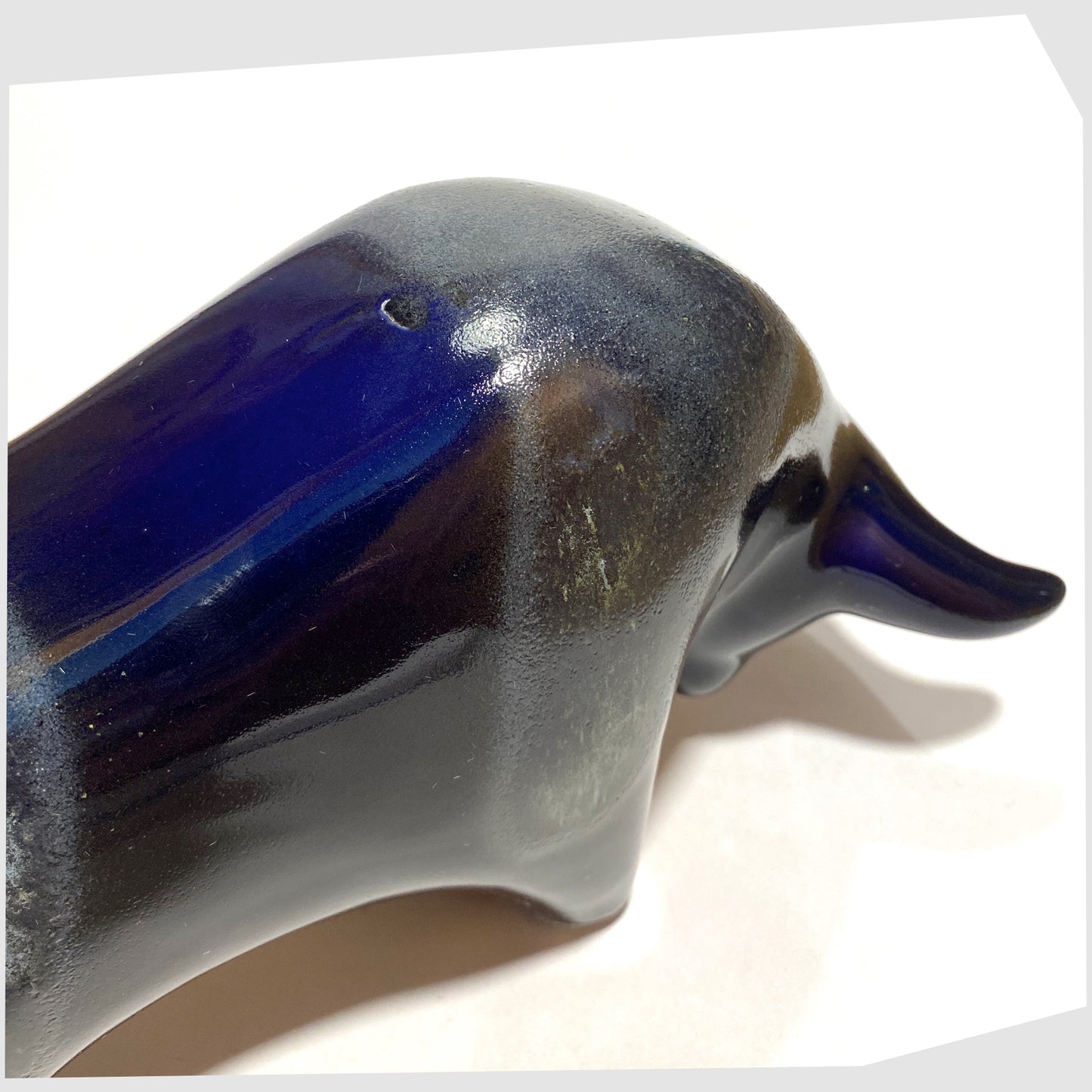 Close up of the Otto Keramik Ceramic Bull in navy and blue Kreta glaze, shown on a white background