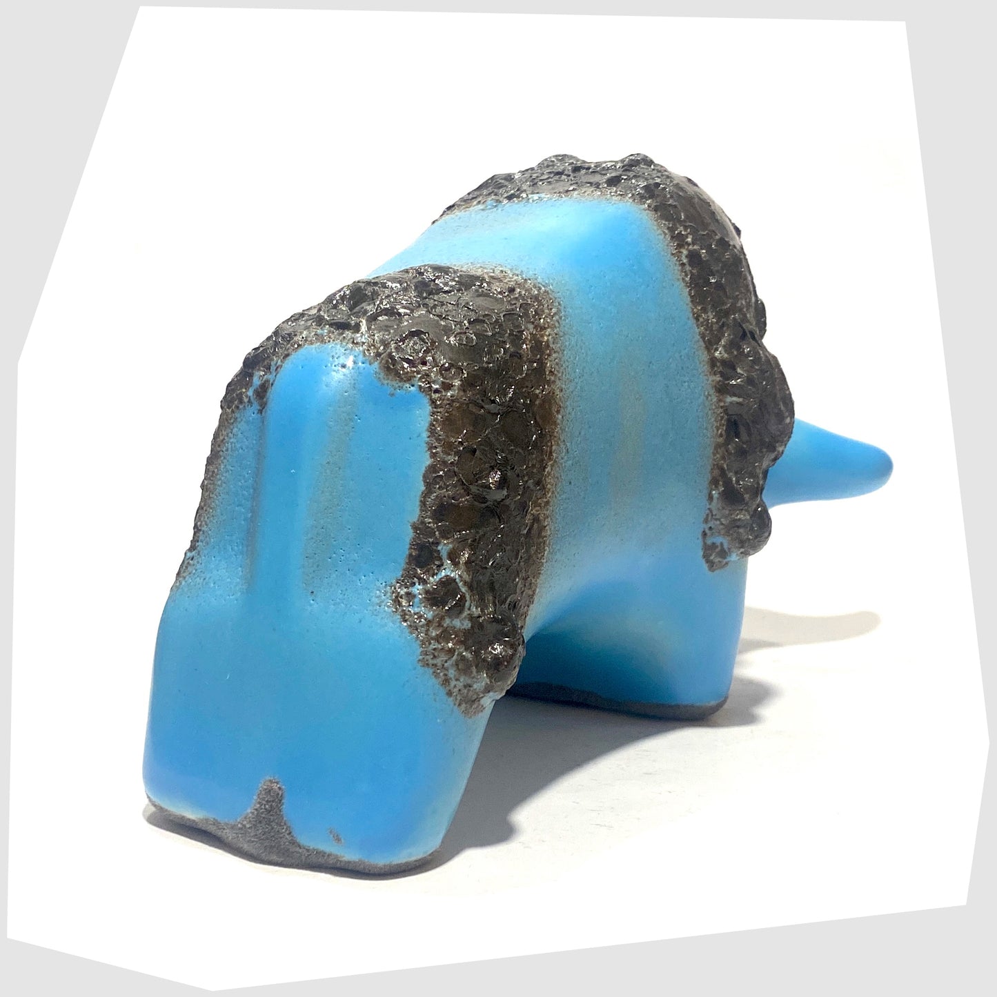 rear of the otto keramik bull in light blue glaze with striped of deep fat lava glaze