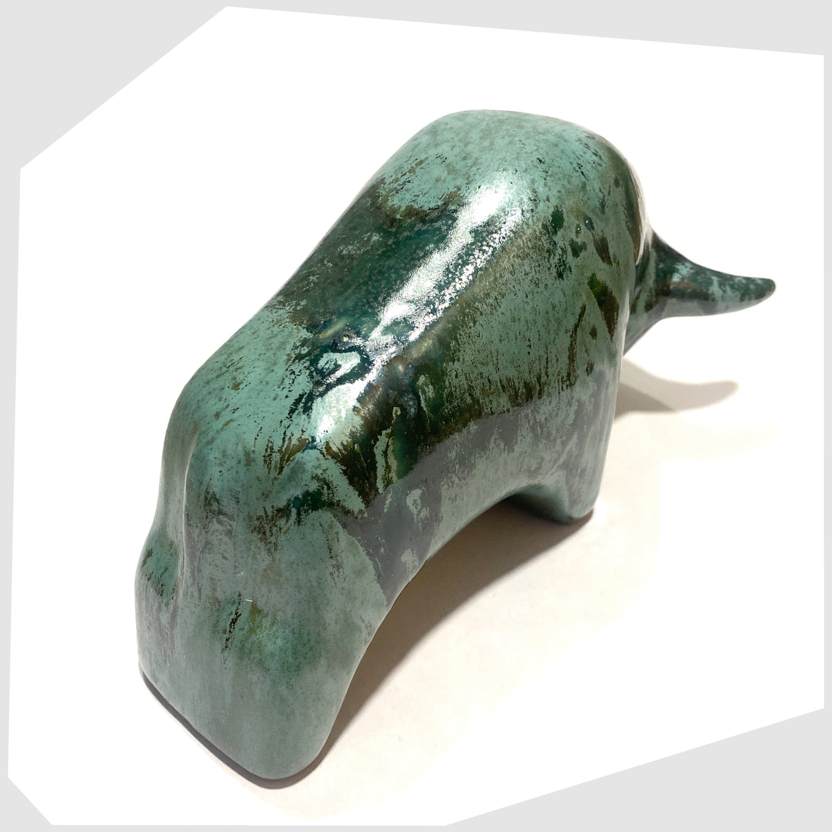 Top view of the Otto Keramik Bull shaped figurine in Malta glaze of rich sea green with darker drip glazing, shown on a white background