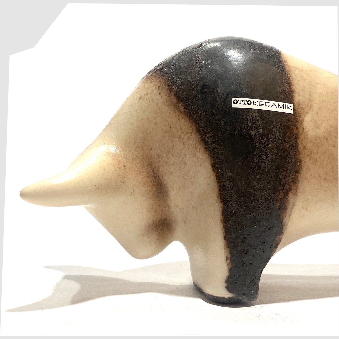 close up of the Otto Keramik Bull in natural glaze with bands of dark brown fat lava