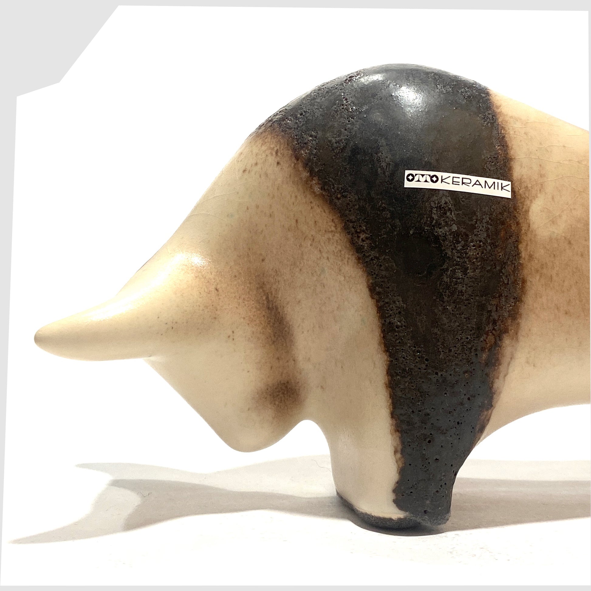close up of the Otto Keramik Bull in natural glaze with bands of dark brown fat lava